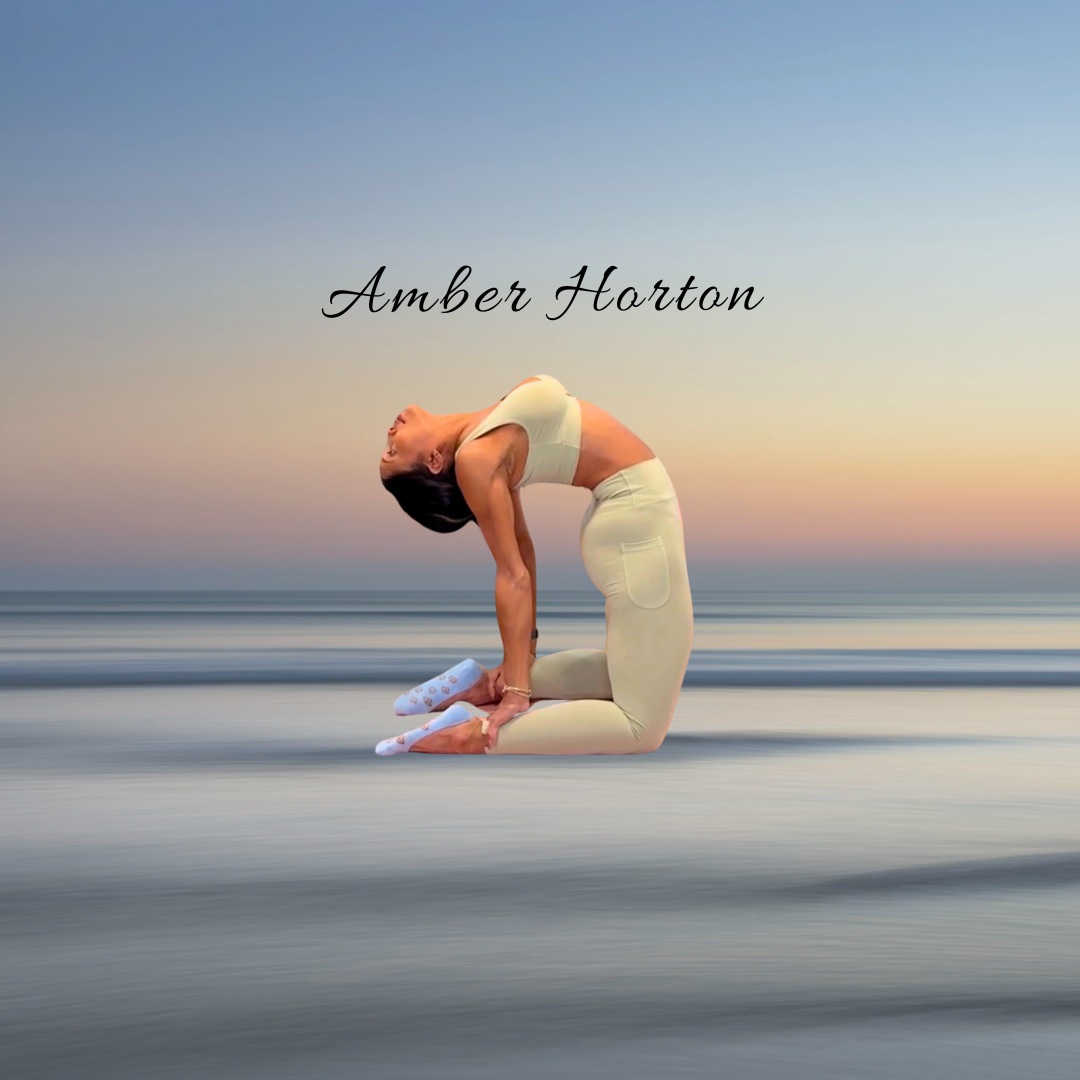 Person practicing yoga on a beach during sunset, performing a backbend pose with a calm sky background.