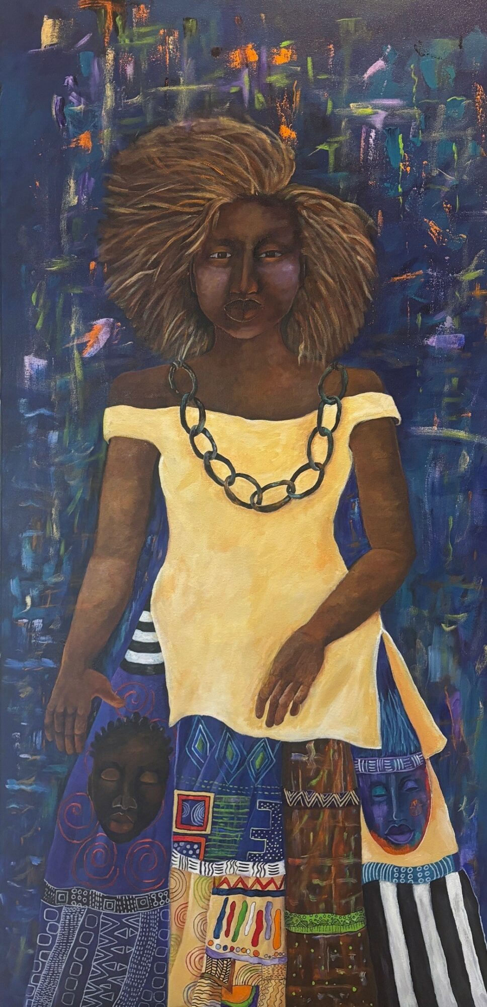 Portrait of a woman with large hair, wearing a yellow dress and a large chain necklace, standing against a colorful background.