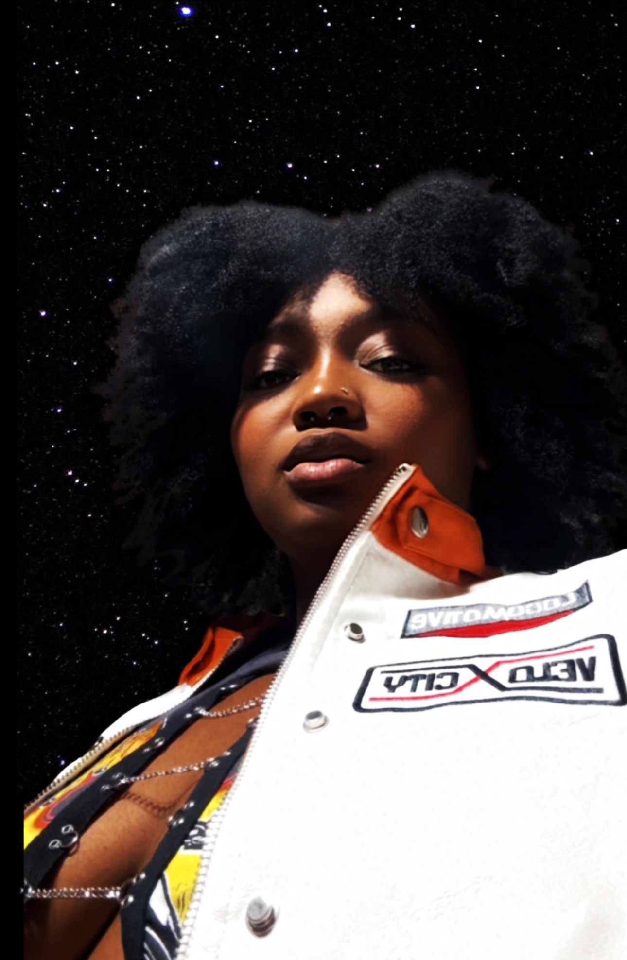 Portrait of a woman with natural hair against a starry night sky background.
