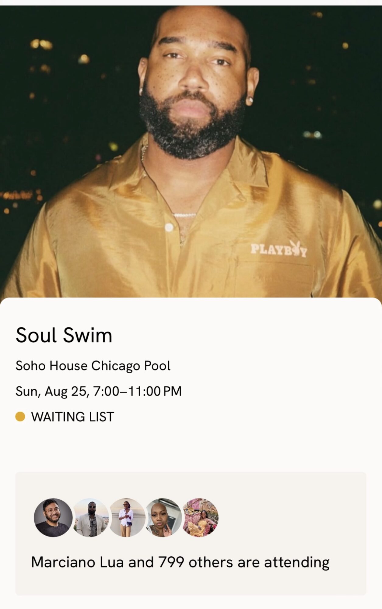 Man with beard wearing a shiny gold shirt, standing outdoors at night.
