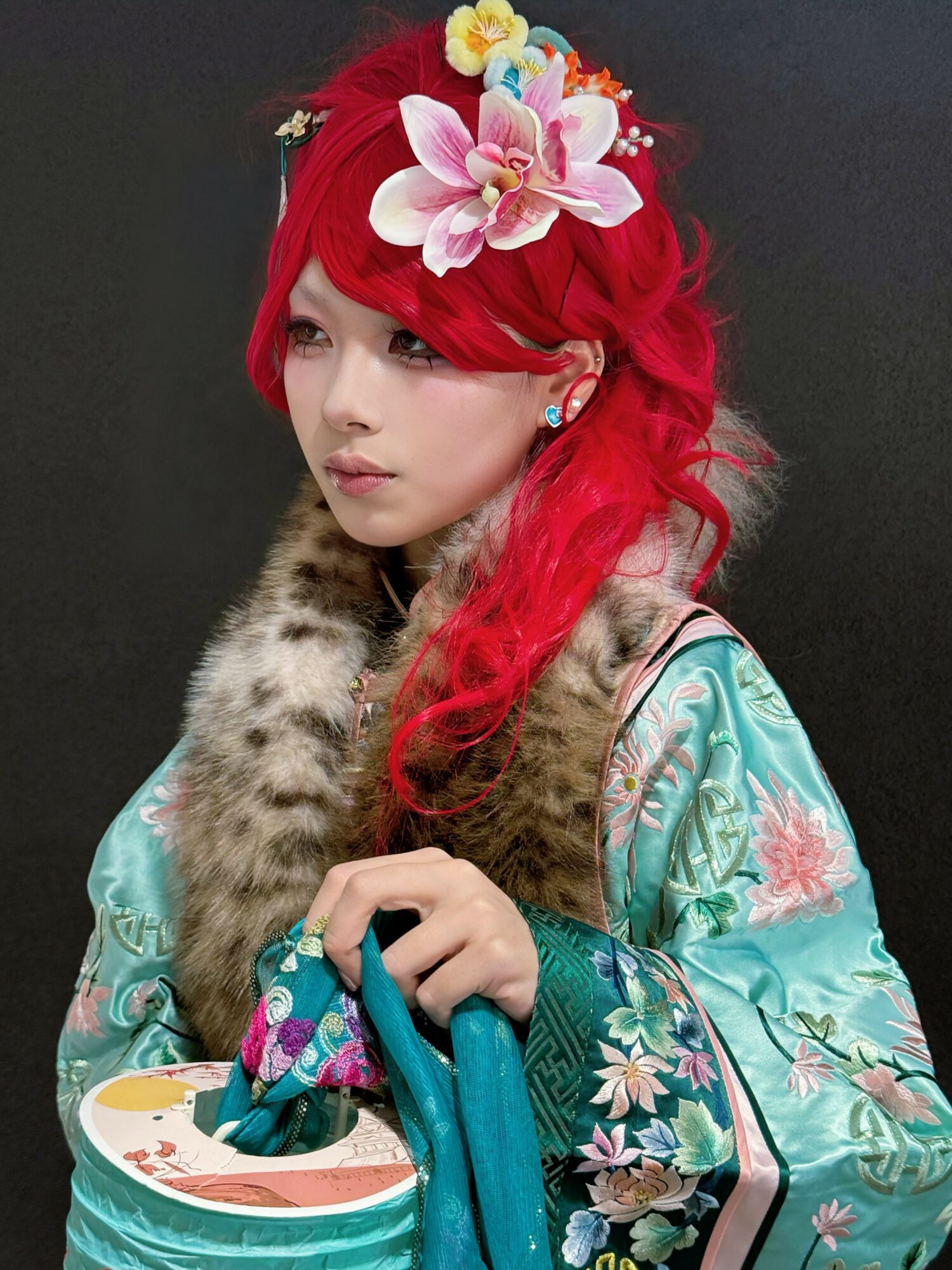 Young woman with red hair wearing floral headpiece and traditional clothing, holding a bowl with a spoon.