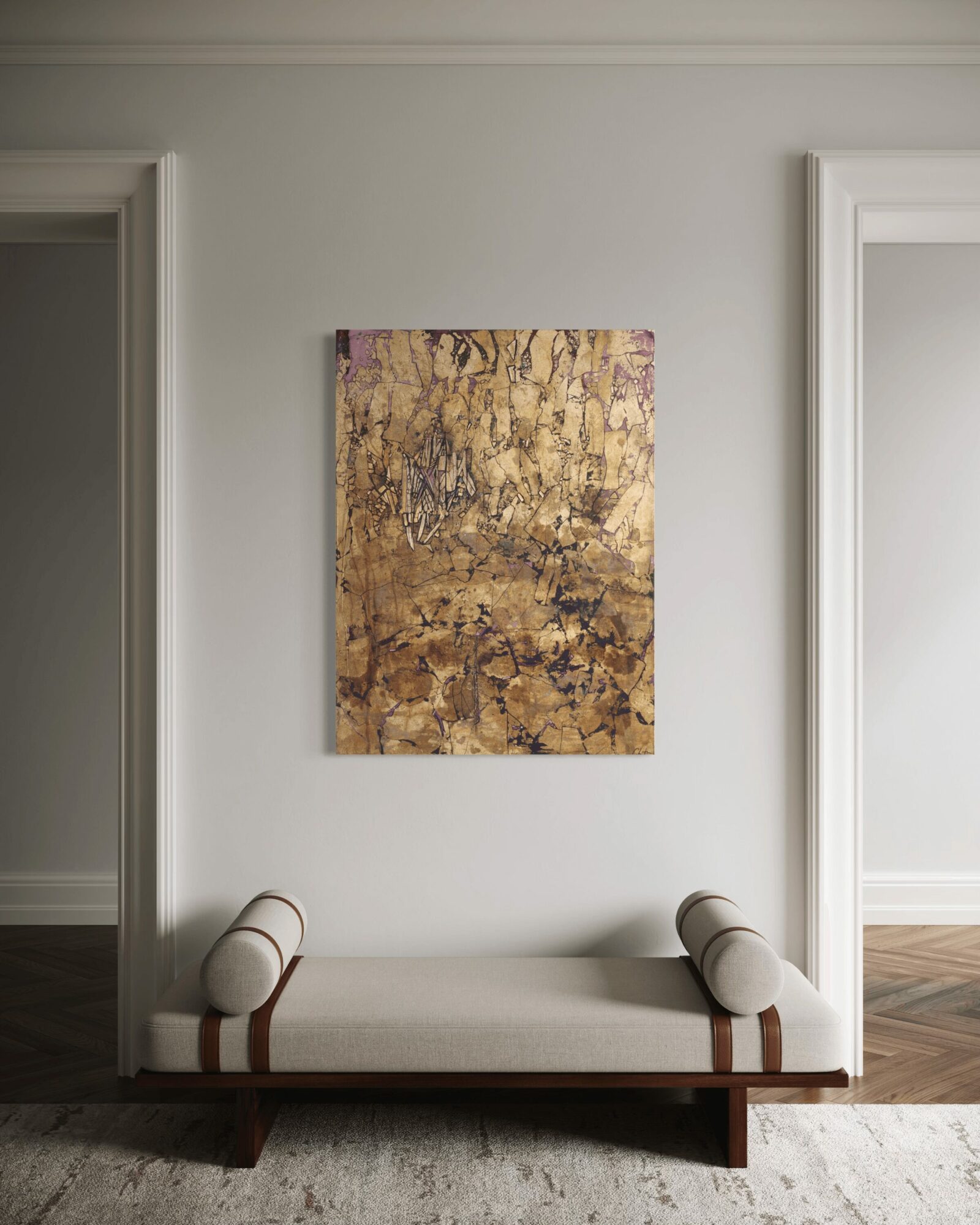 Abstract painting with gold, purple, and brown tones hanging above a white bench in a room with white walls.