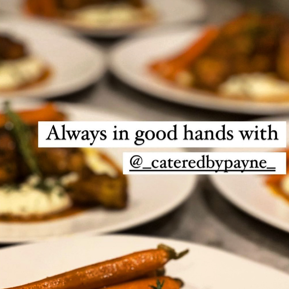Close-up of a carrot on a white plate with blurred dishes in the background.