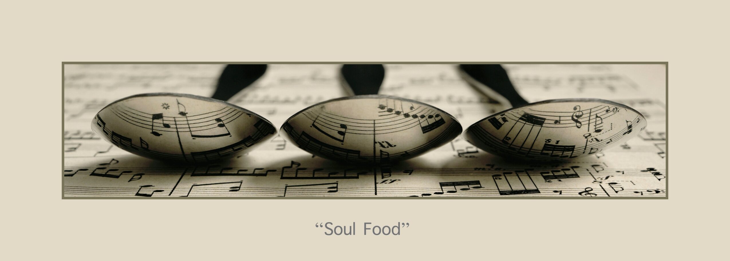 Three metallic spoons placed on sheet music with musical notes, titled 'Soul Food'.