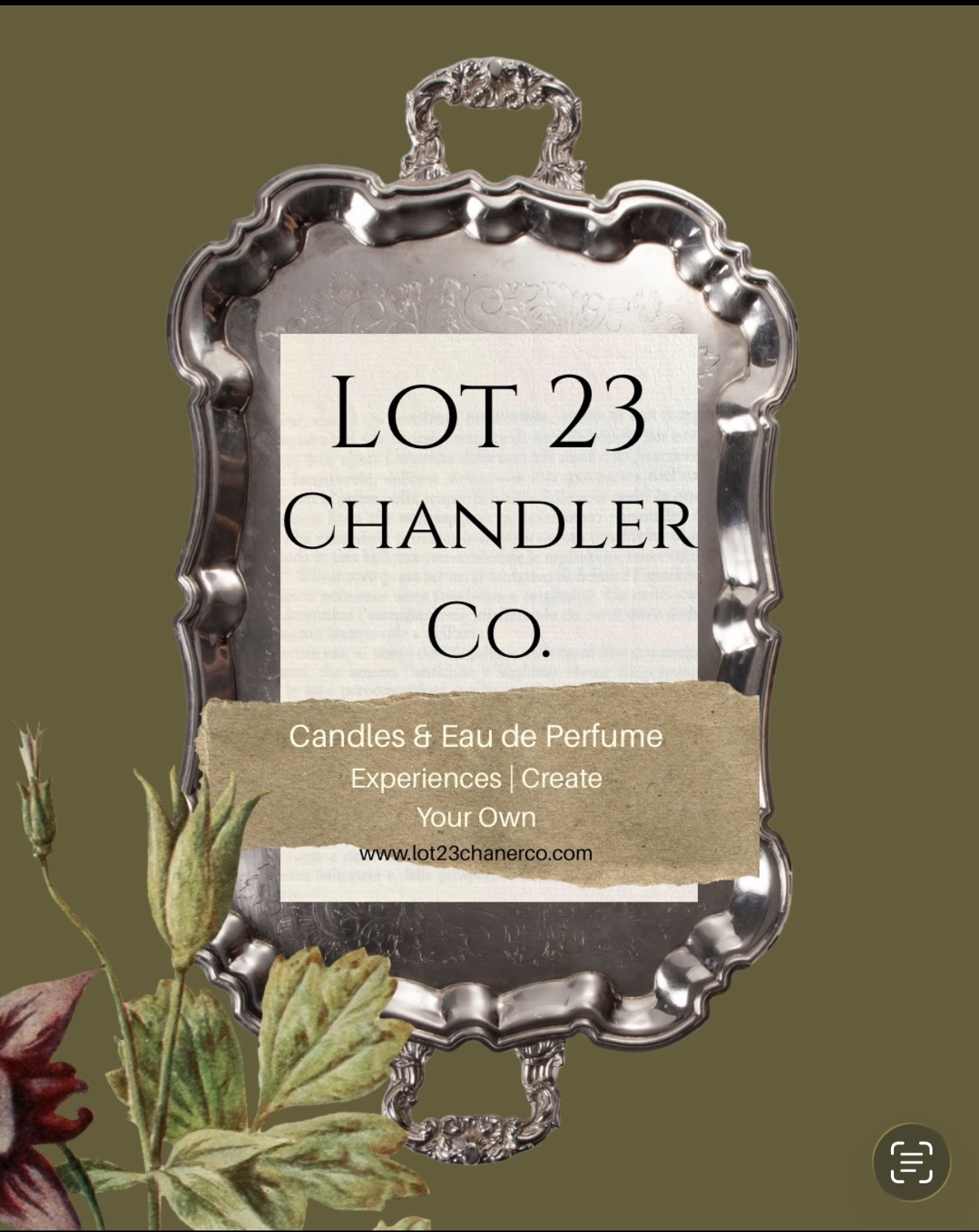 Mirror with ornate frame displaying a label for Lot 23 Chandler Co. candles and Eau de Parfum, with leaves at bottom left.
