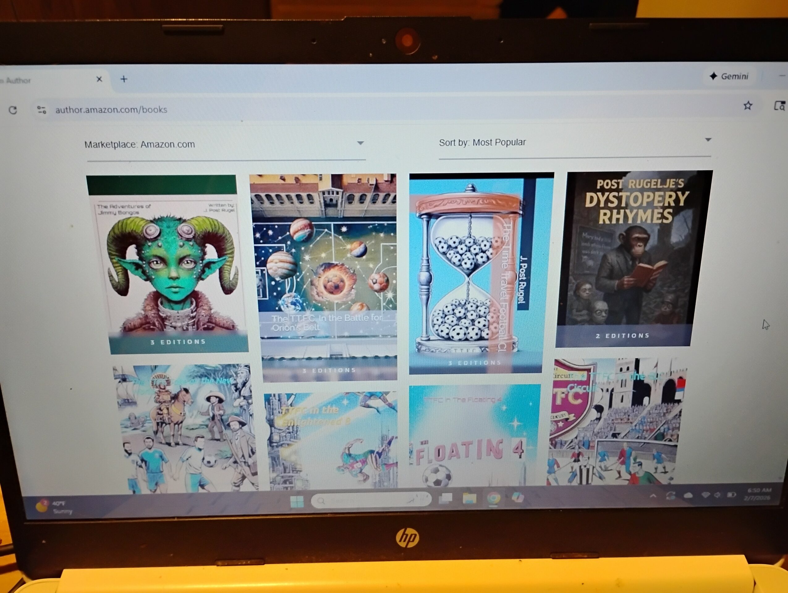 Laptop screen displaying a webpage with various colorful images and book covers, viewed from a slightly tilted angle.