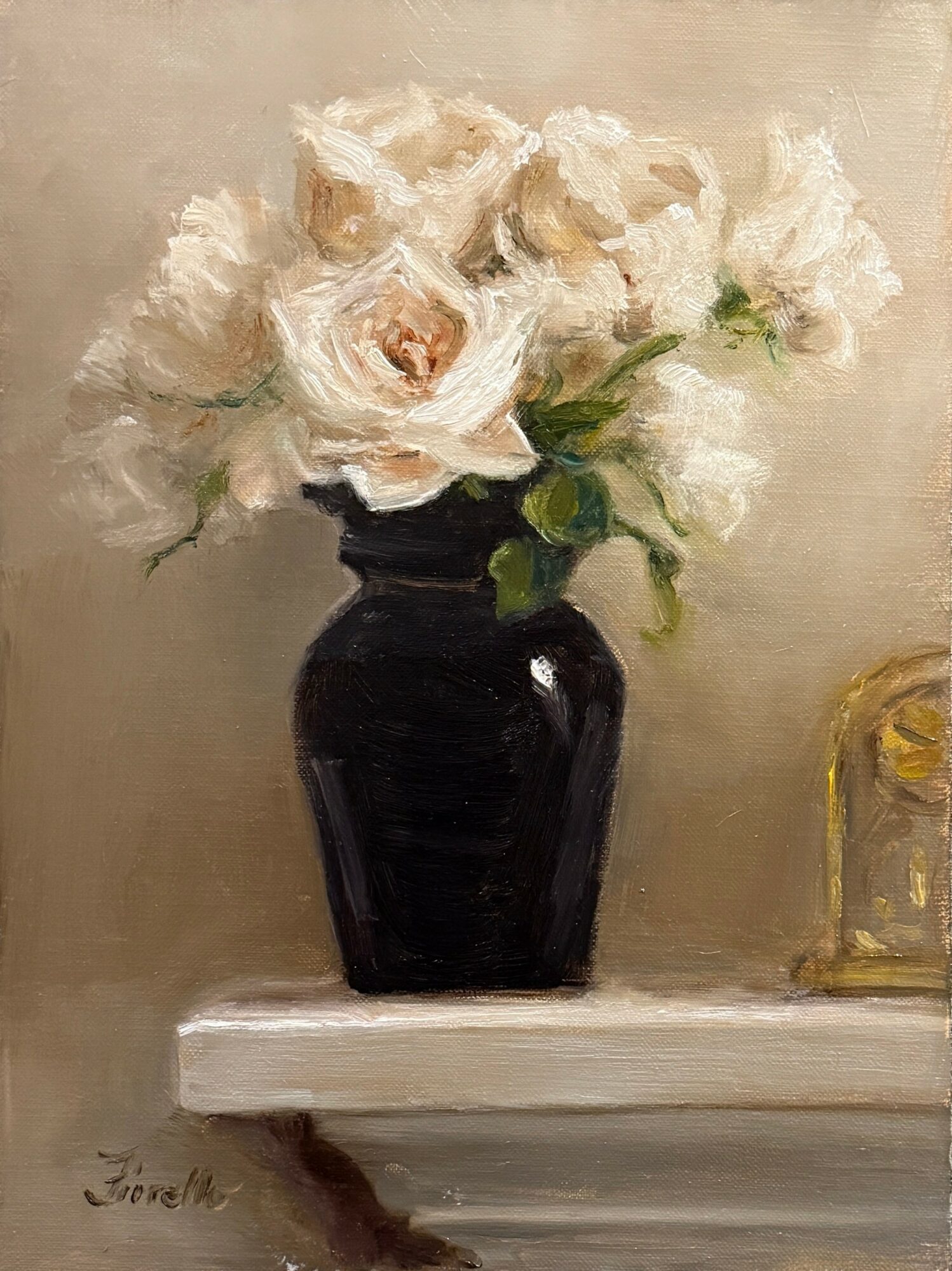 A black vase with white roses on a white surface, with a beige background.