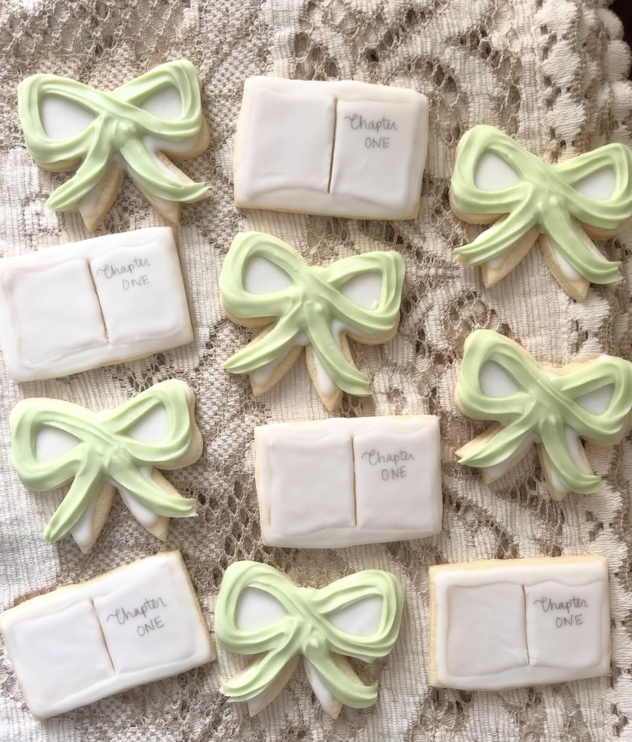 Decorative soap bars and bows arranged on a textured surface, with some soap wrapped in paper labeled 'Thank you' and 'Chapter ONE'.