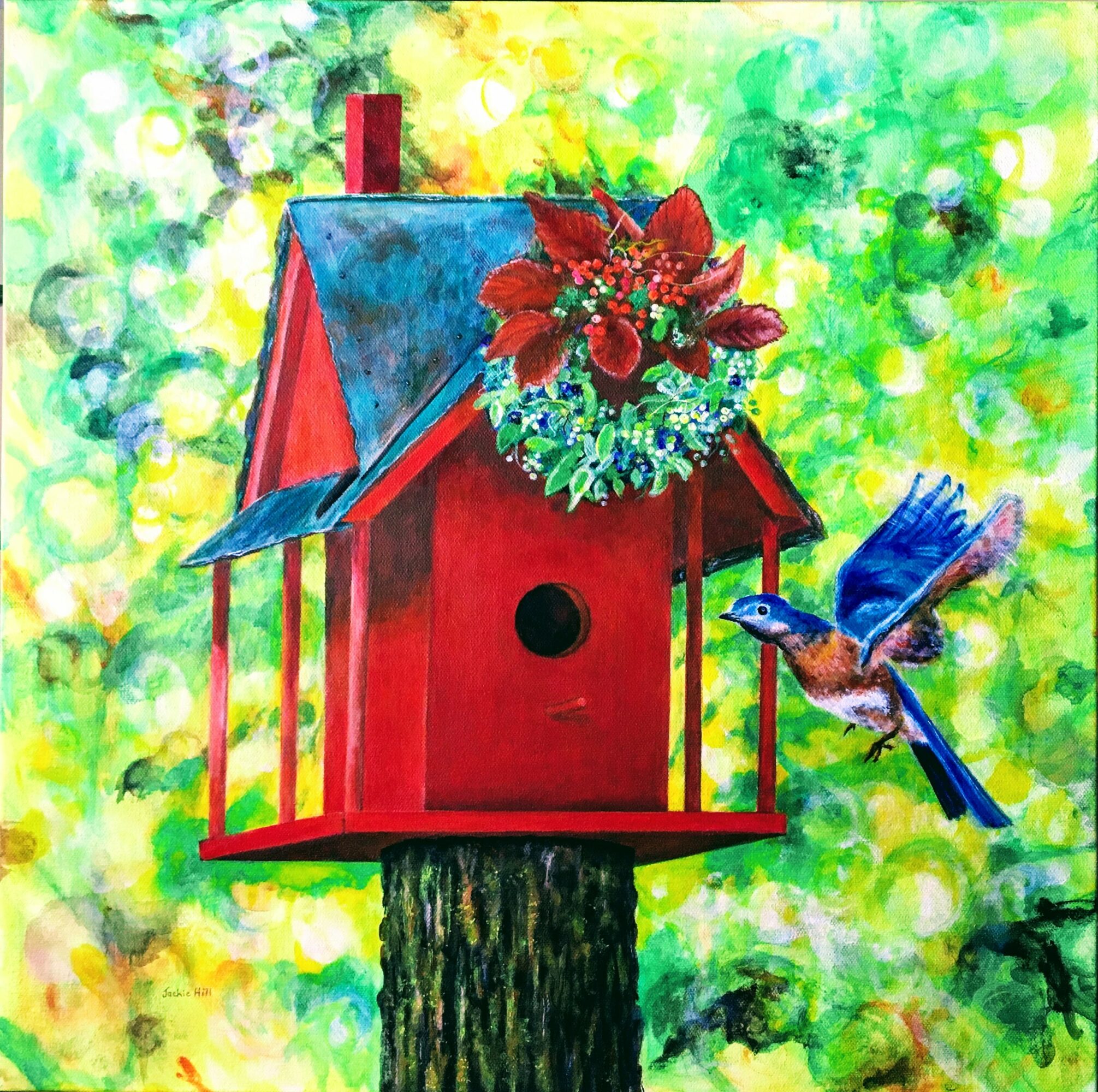 Red birdhouse on a tree trunk with a blue bird flying nearby, surrounded by green and yellow foliage.