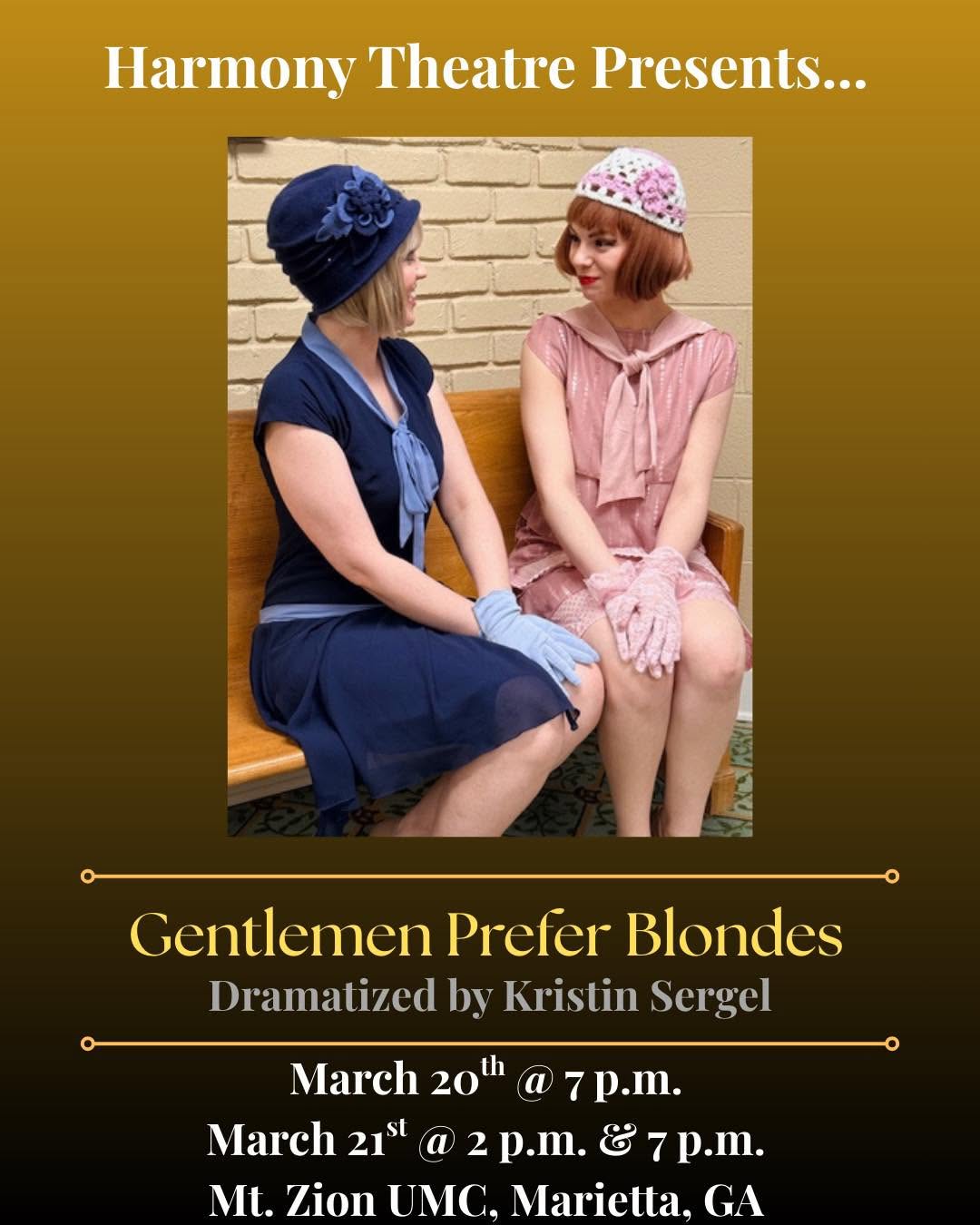 Two women sit on a bench, talking, with a brick wall background. One wears a dark dress and hat, the other a pink dress and hat.
