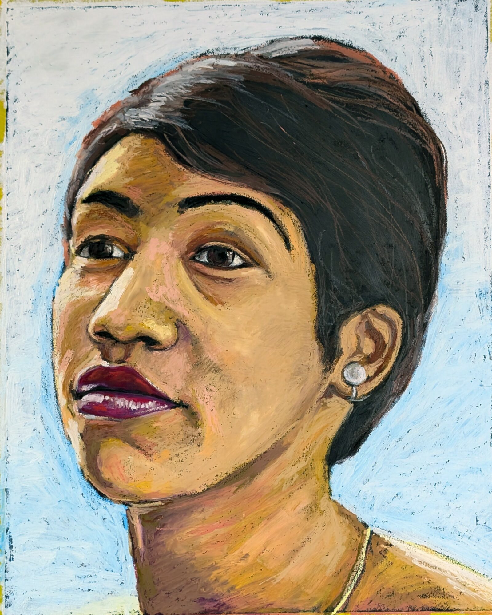 Portrait of a woman with short dark hair, wearing earrings, against a light background.