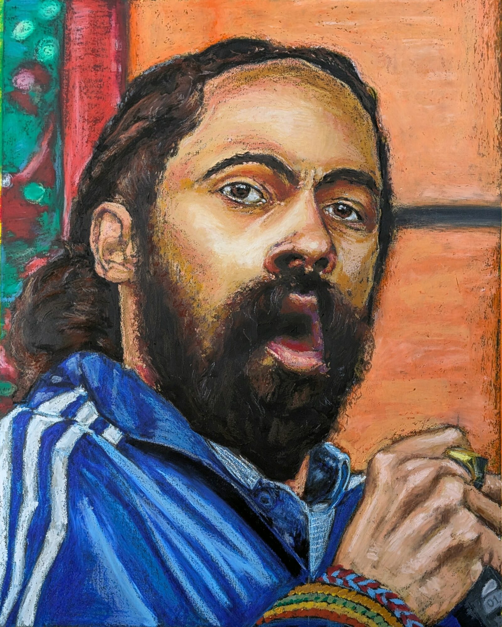 Portrait of a man with long hair and a beard, wearing a blue jacket, holding a pen, with colorful background.