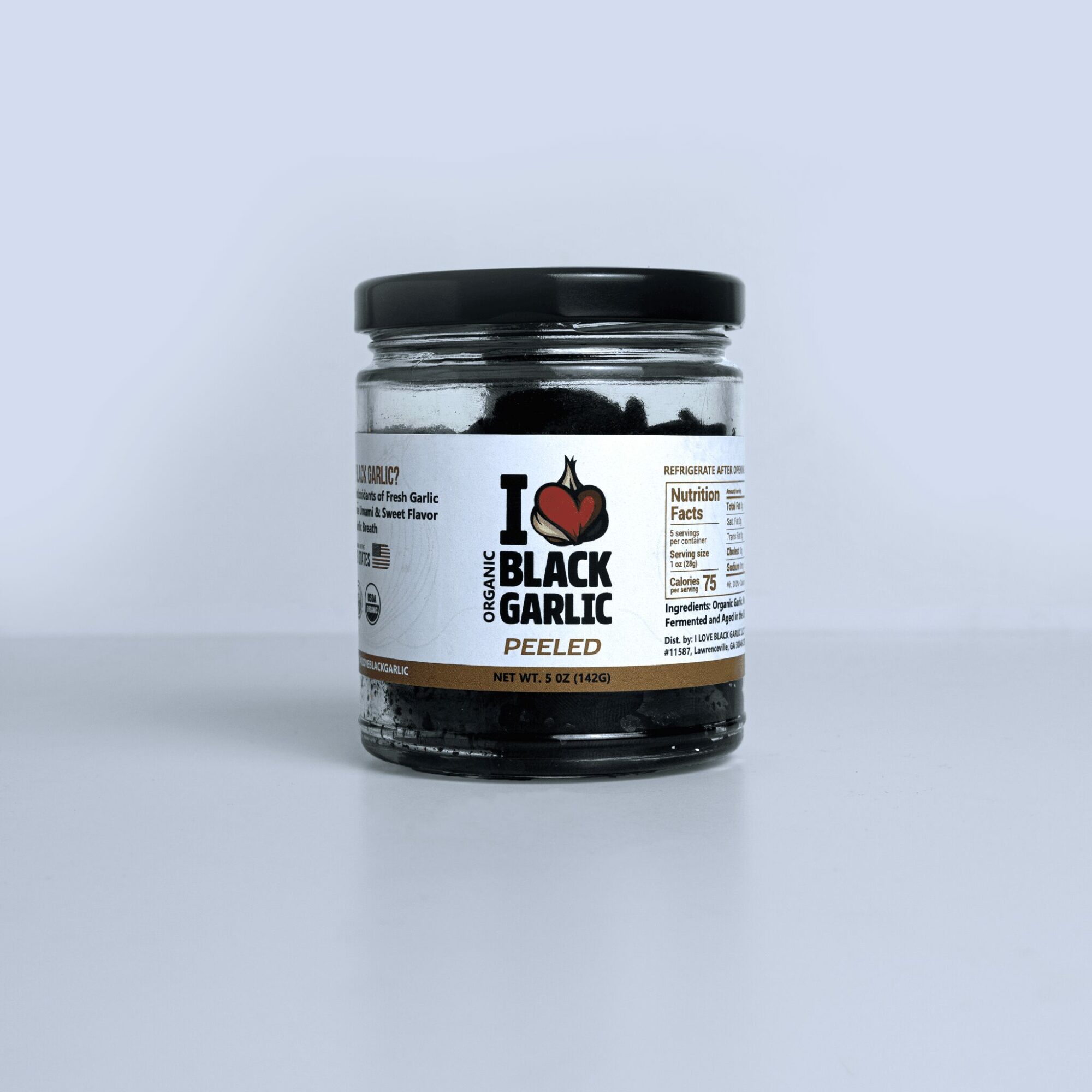 Jar of black garlic peeled with label showing product name and nutrition facts, against a light background.