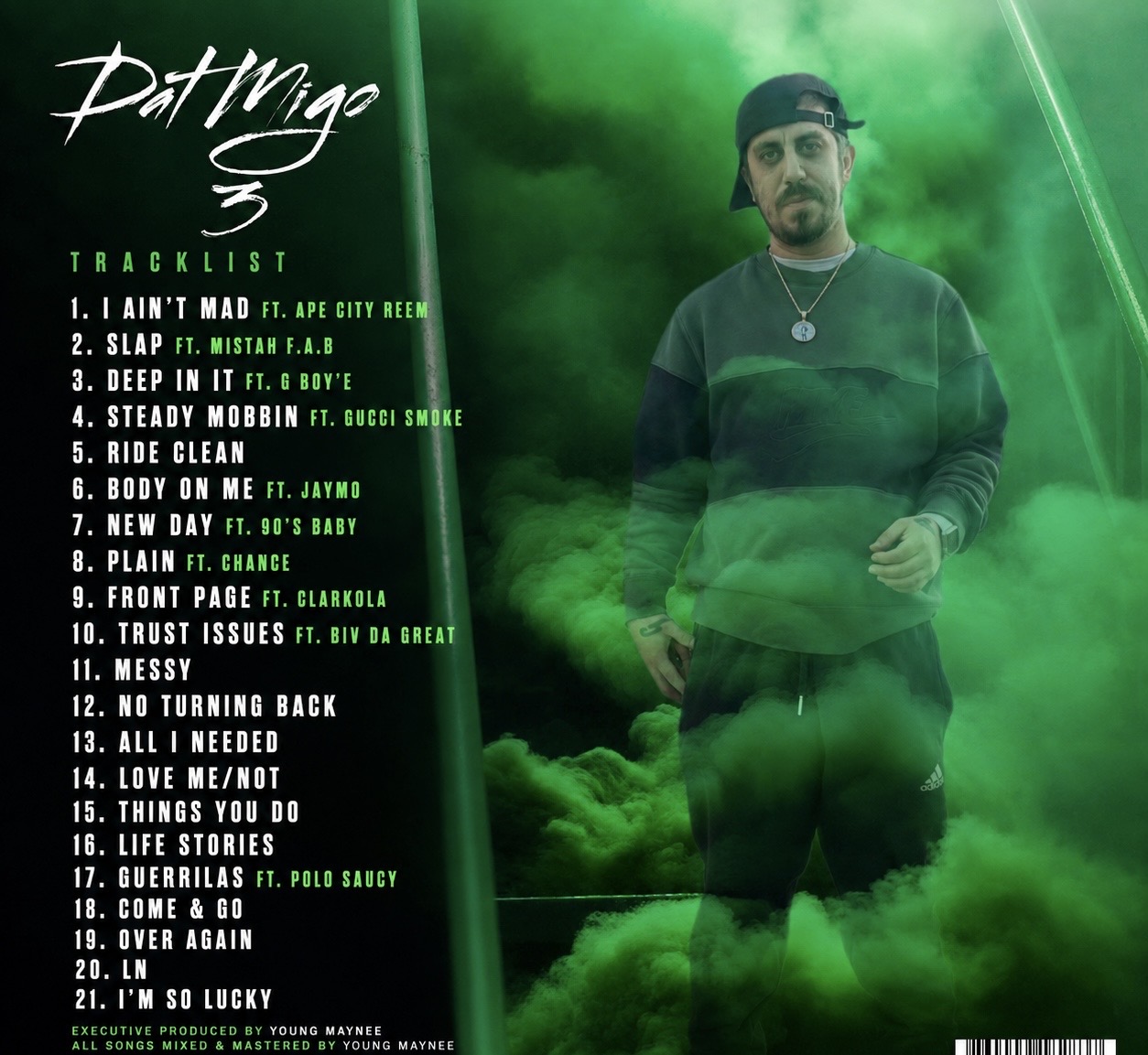 Man in black hoodie and cap standing in green smoke with tracklist on the left side.