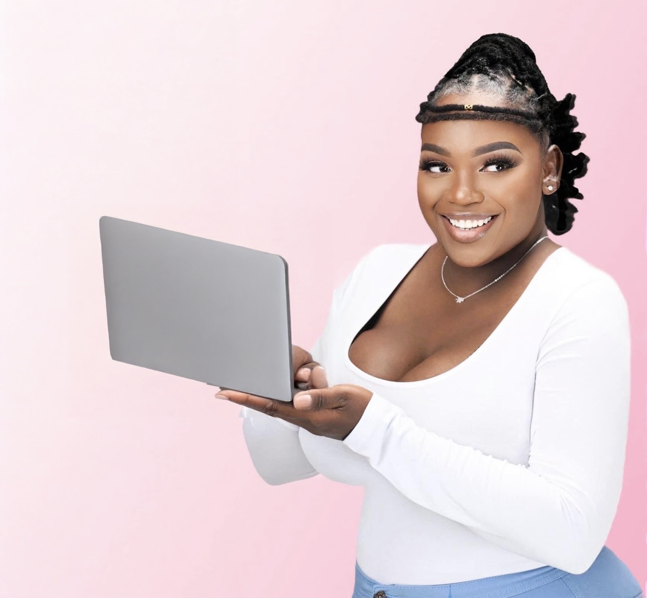 Smiling woman holding a laptop against a pink background, wearing a white top and necklace.
