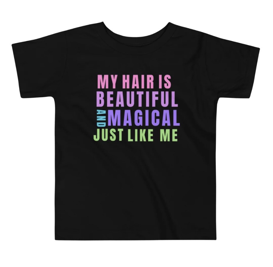 Black T-shirt with colorful text reading 'My hair is beautiful and magical just like me'.