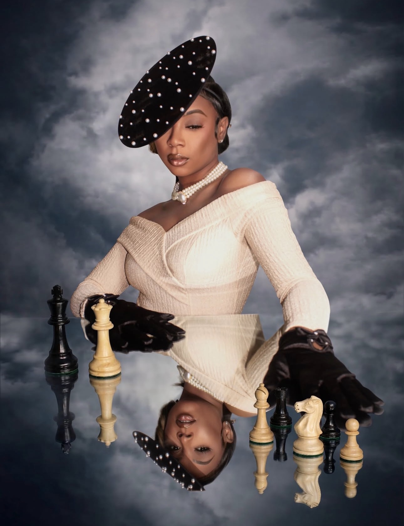 Woman in vintage dress with hat, playing chess against a reflective surface, cloudy sky background, reflection visible, black gloves, pearl necklace.