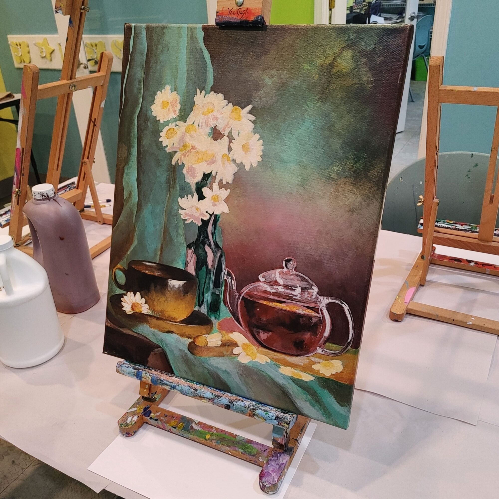 Still life painting of a vase with white flowers, a teapot, and a bowl on a table, with a dark background.