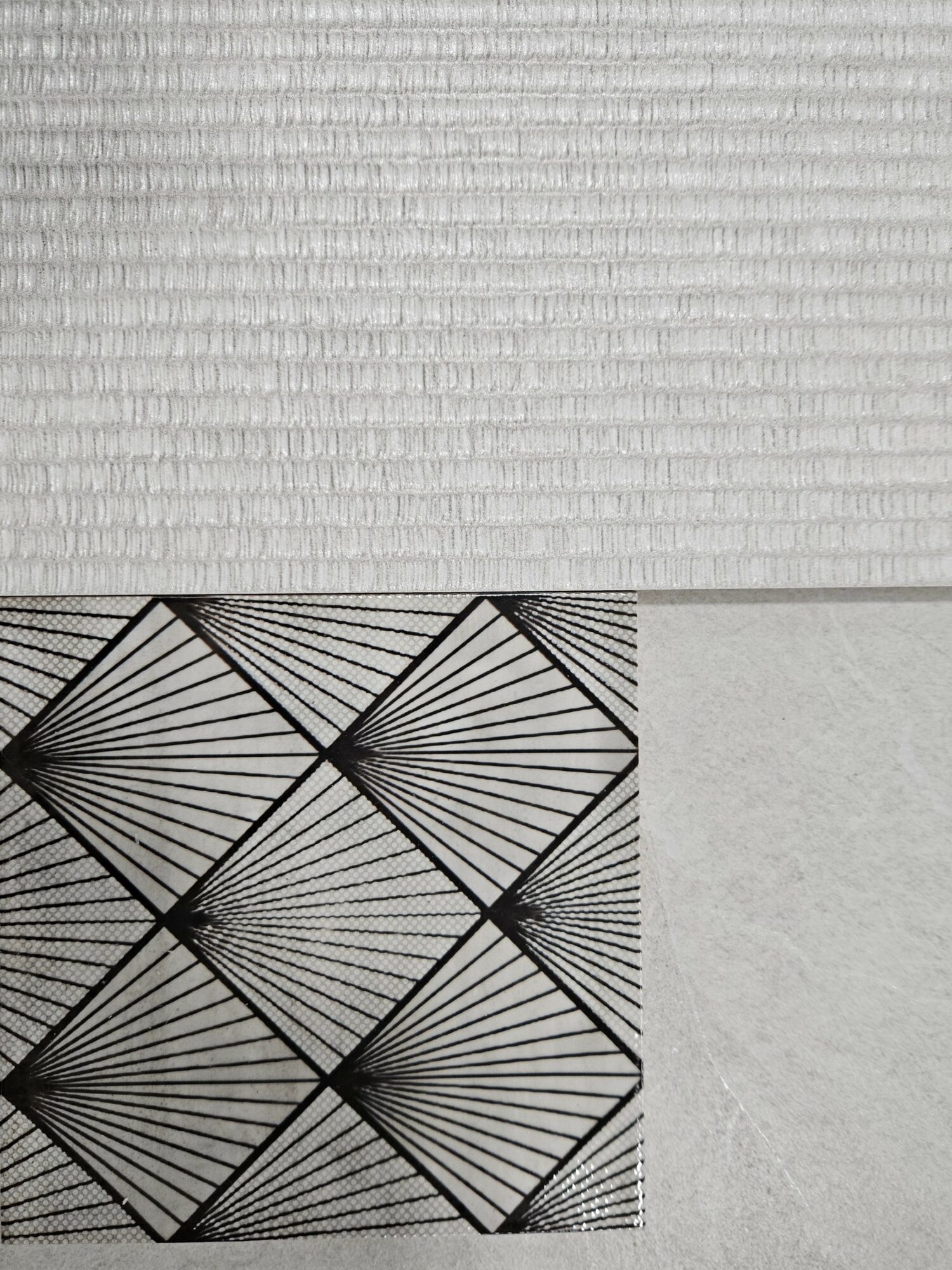 Patterned paper with black geometric lines on a white background, divided into sections with different textures.