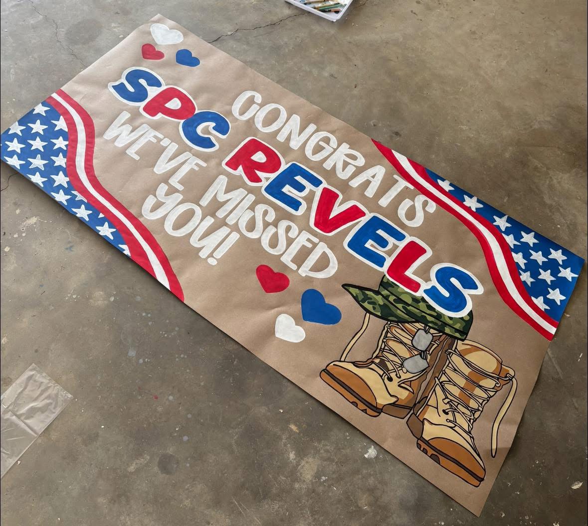 Celebratory banner with boots, stars, and hearts, reading