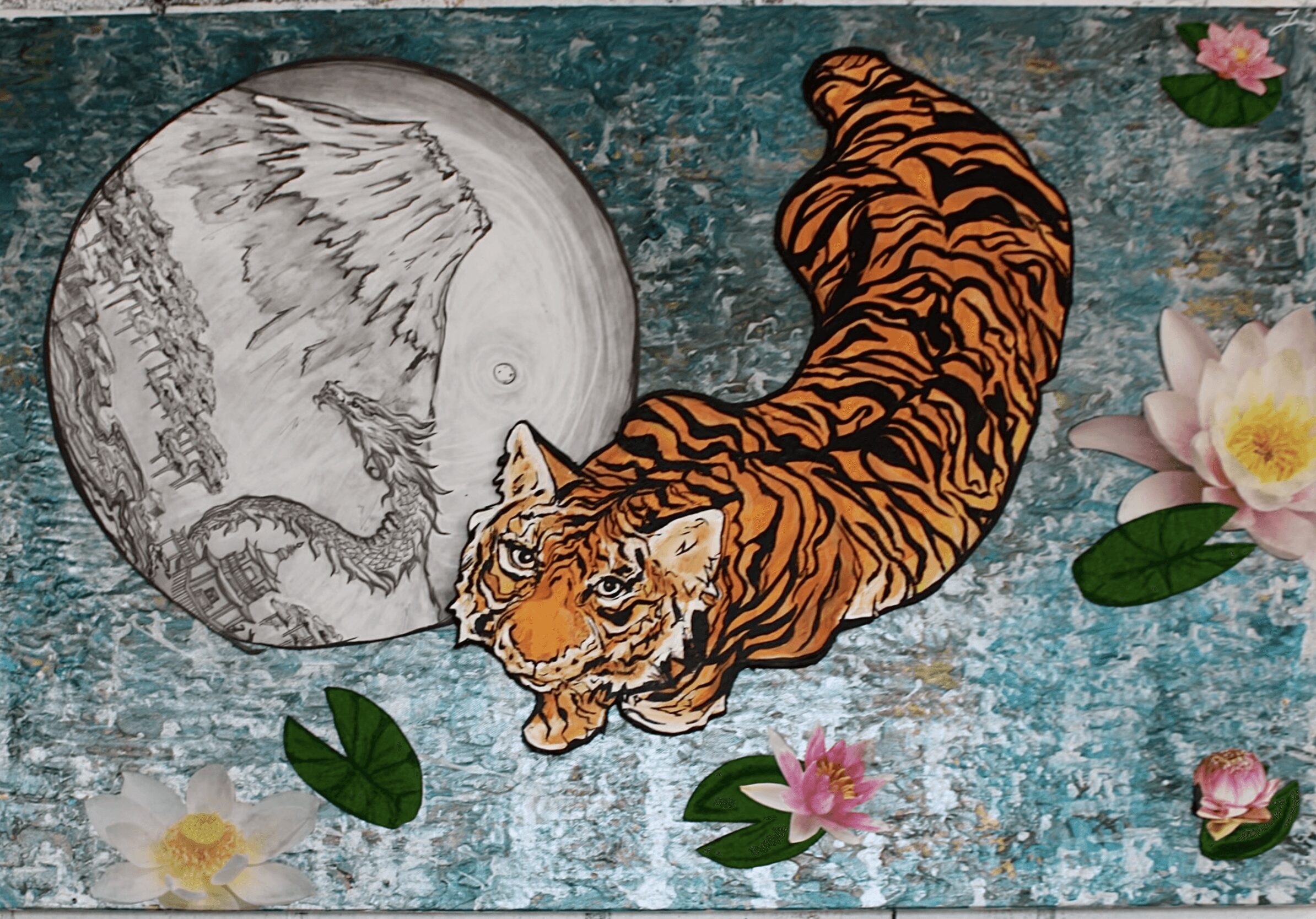 A tiger lying on a textured surface with flowers and a moon illustration nearby.