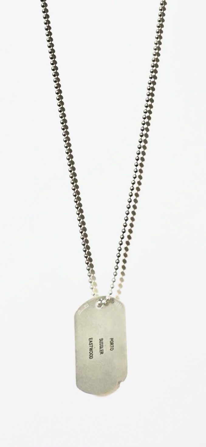 Double-layered chain necklace with a rectangular pendant, plain surface, and engraved text, against a white background.