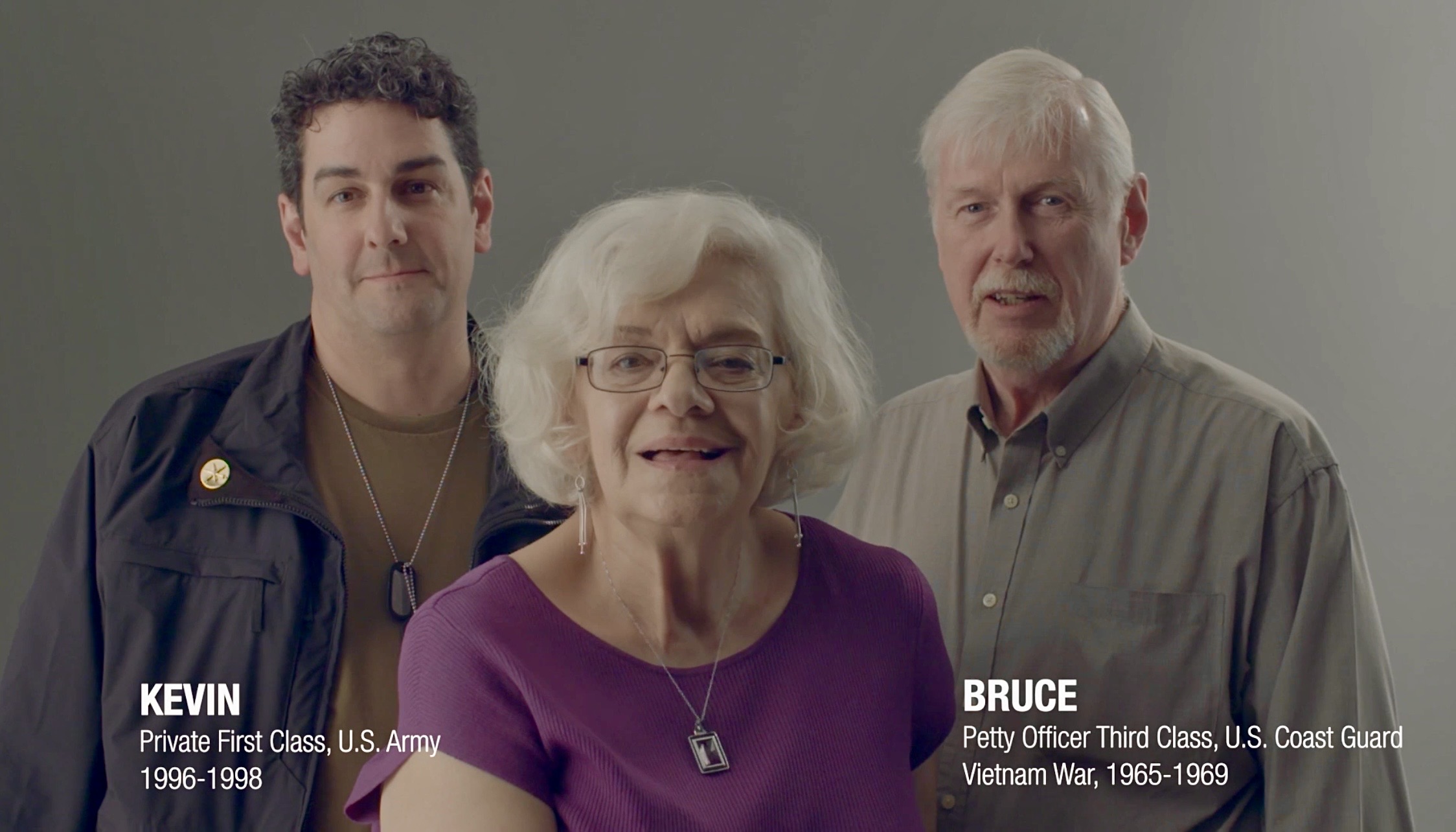 Three people, two men and one woman, standing together indoors, smiling, with text indicating names and titles.