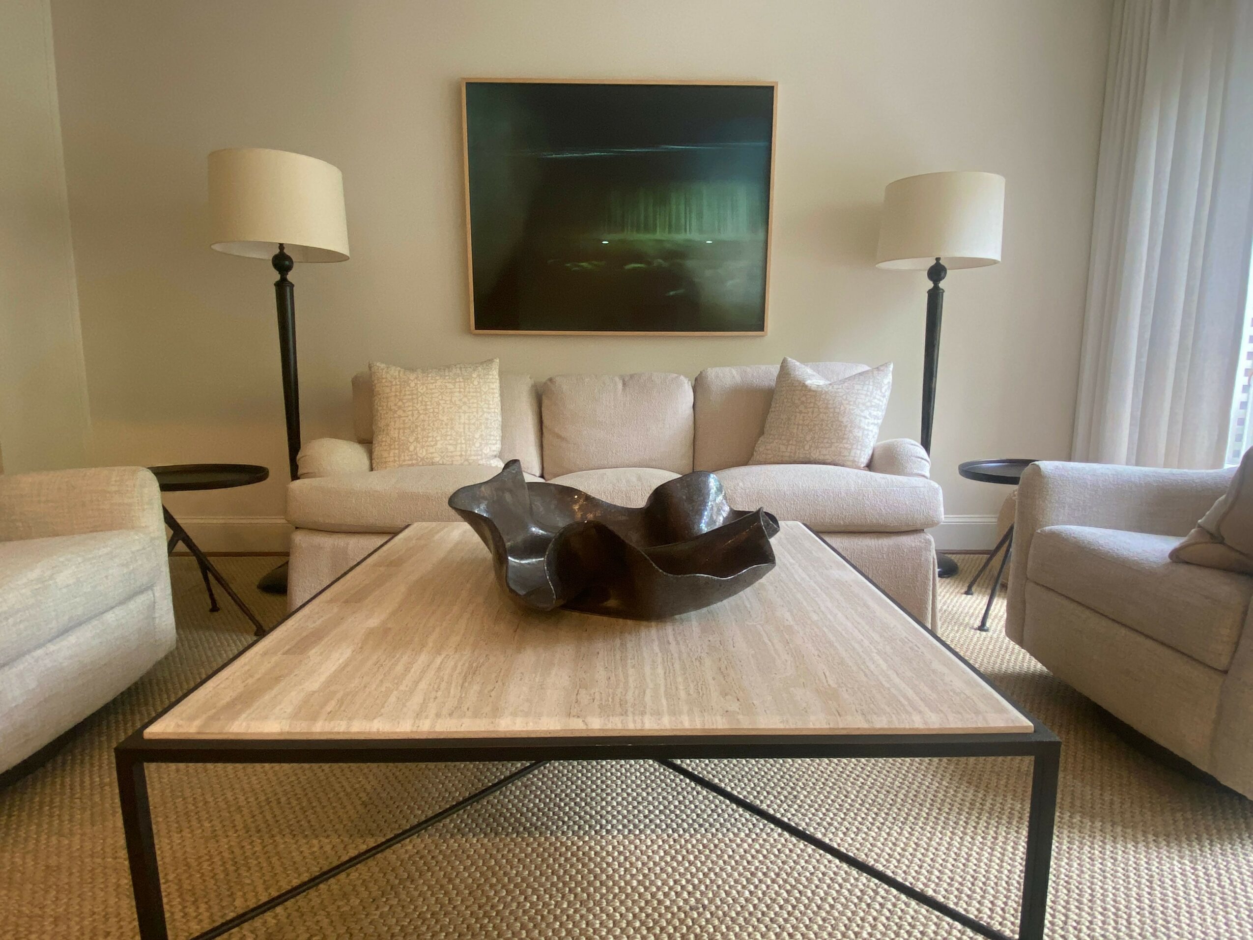 Living room with a wooden table, two hanging lamps, a TV, and sofas, viewed from above.