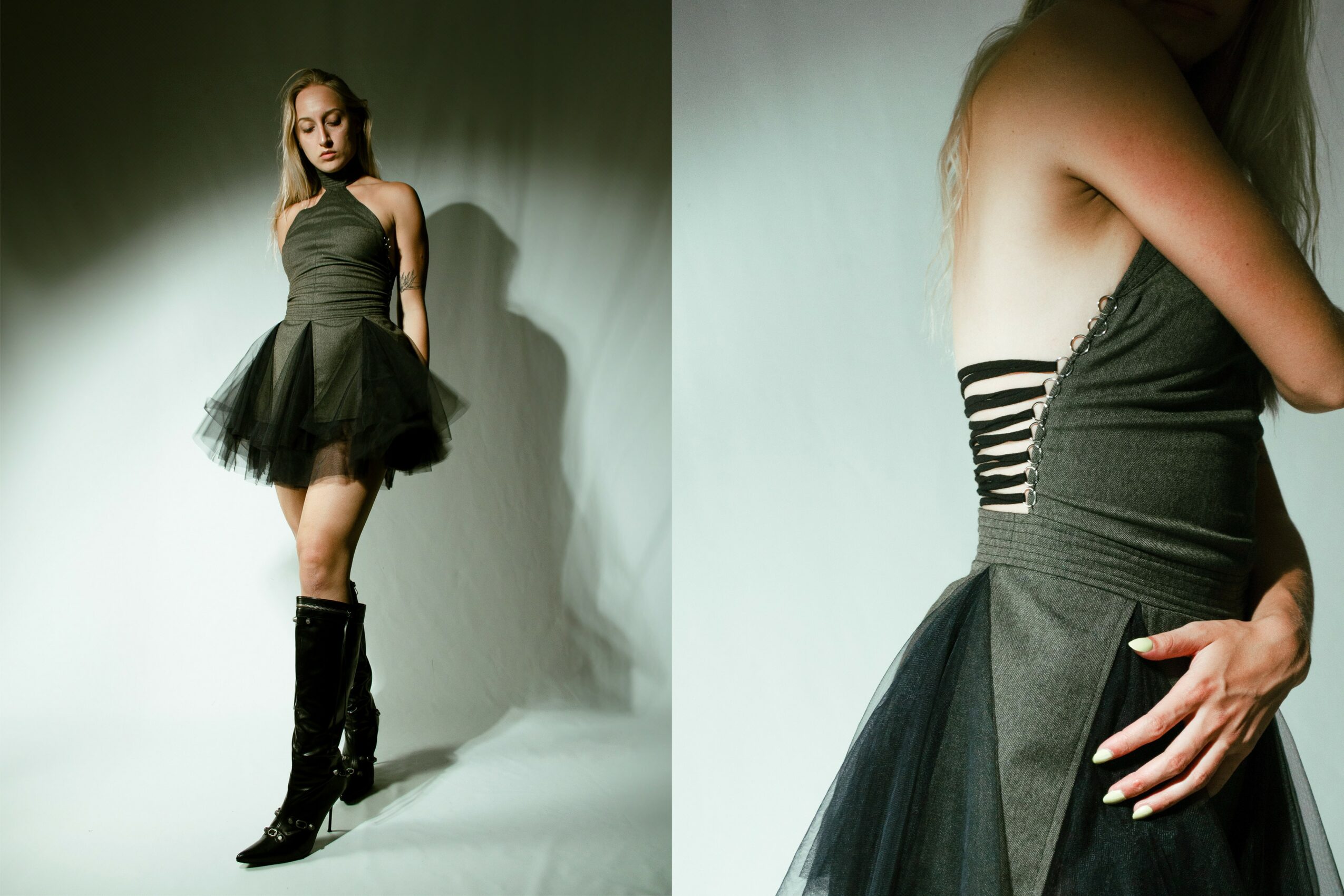 A woman in a strapless black dress and tall black boots stands against a plain background.