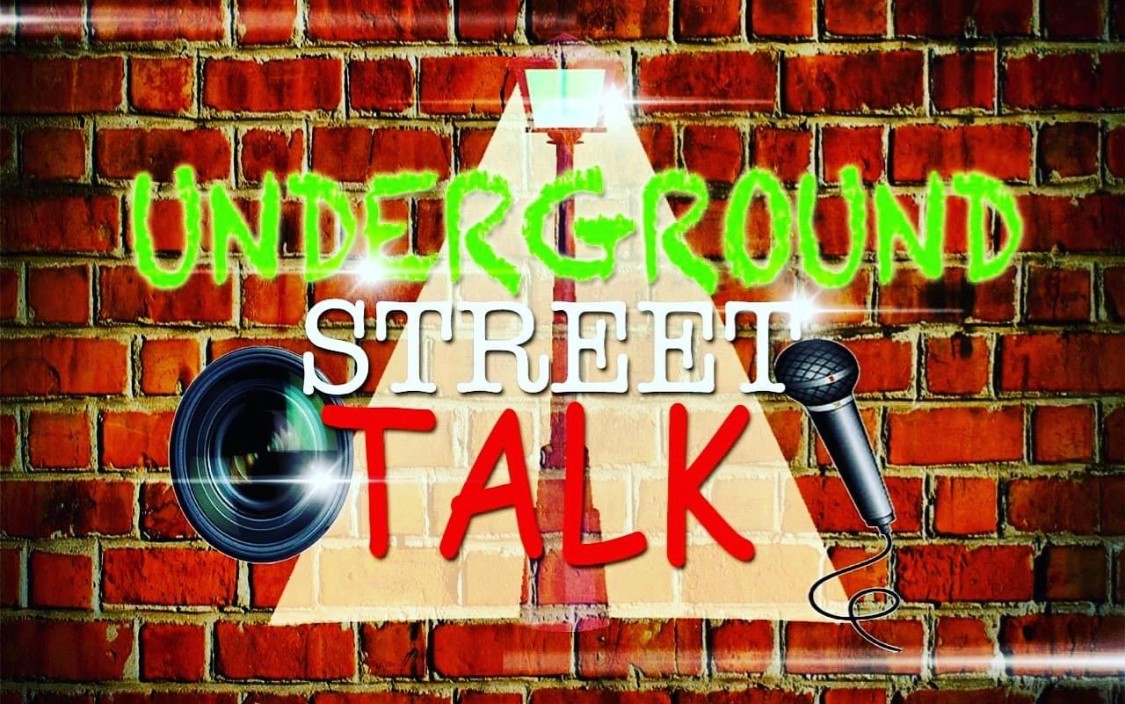Graffiti-style sign on brick wall reads 'UNDERGROUND STREET TALK' with microphone and speaker images.