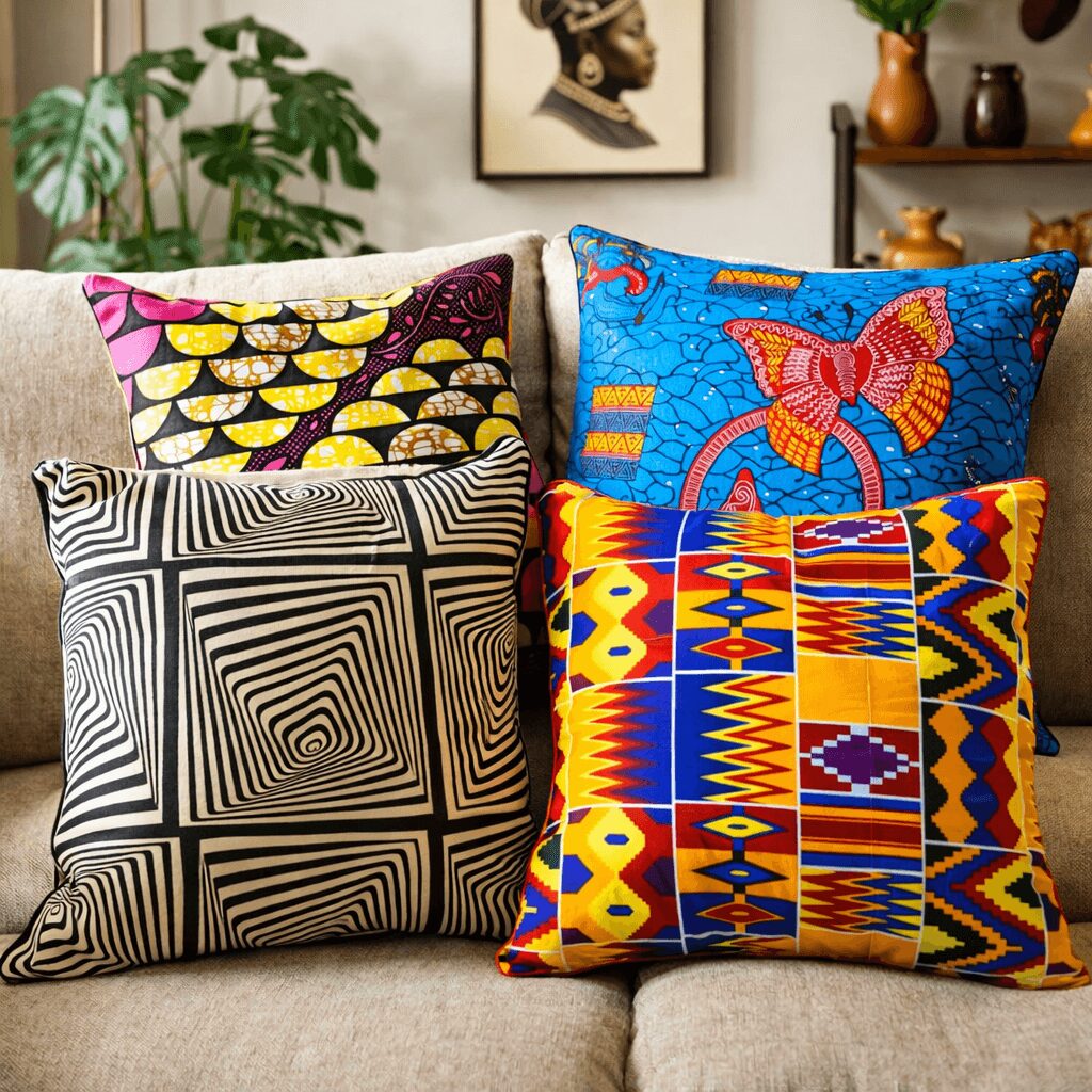 Four colorful decorative pillows with geometric and abstract patterns on a sofa, in a living room setting.