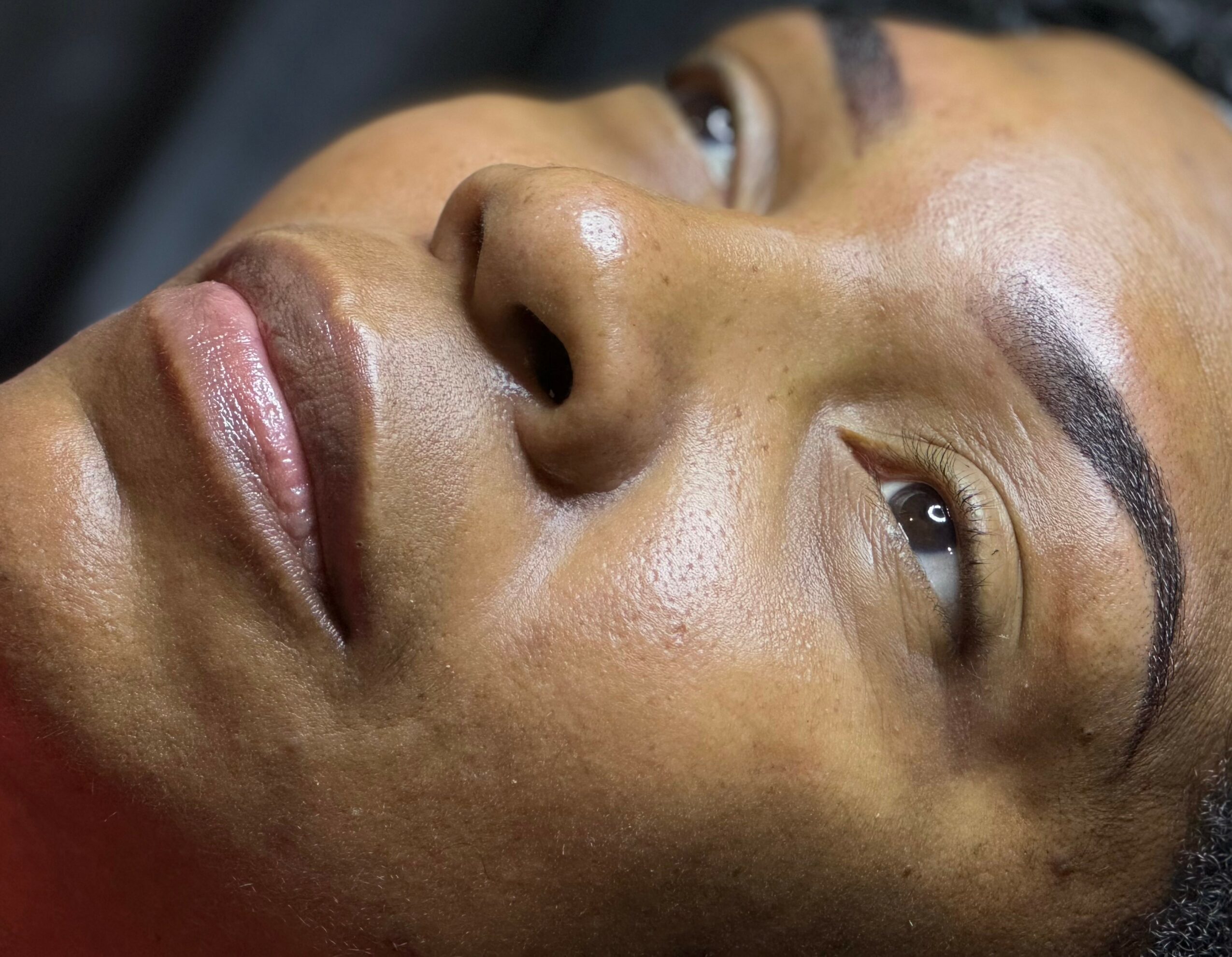 Close-up of a woman's face showing her eyes, nose, and lips, with smooth skin and natural features.