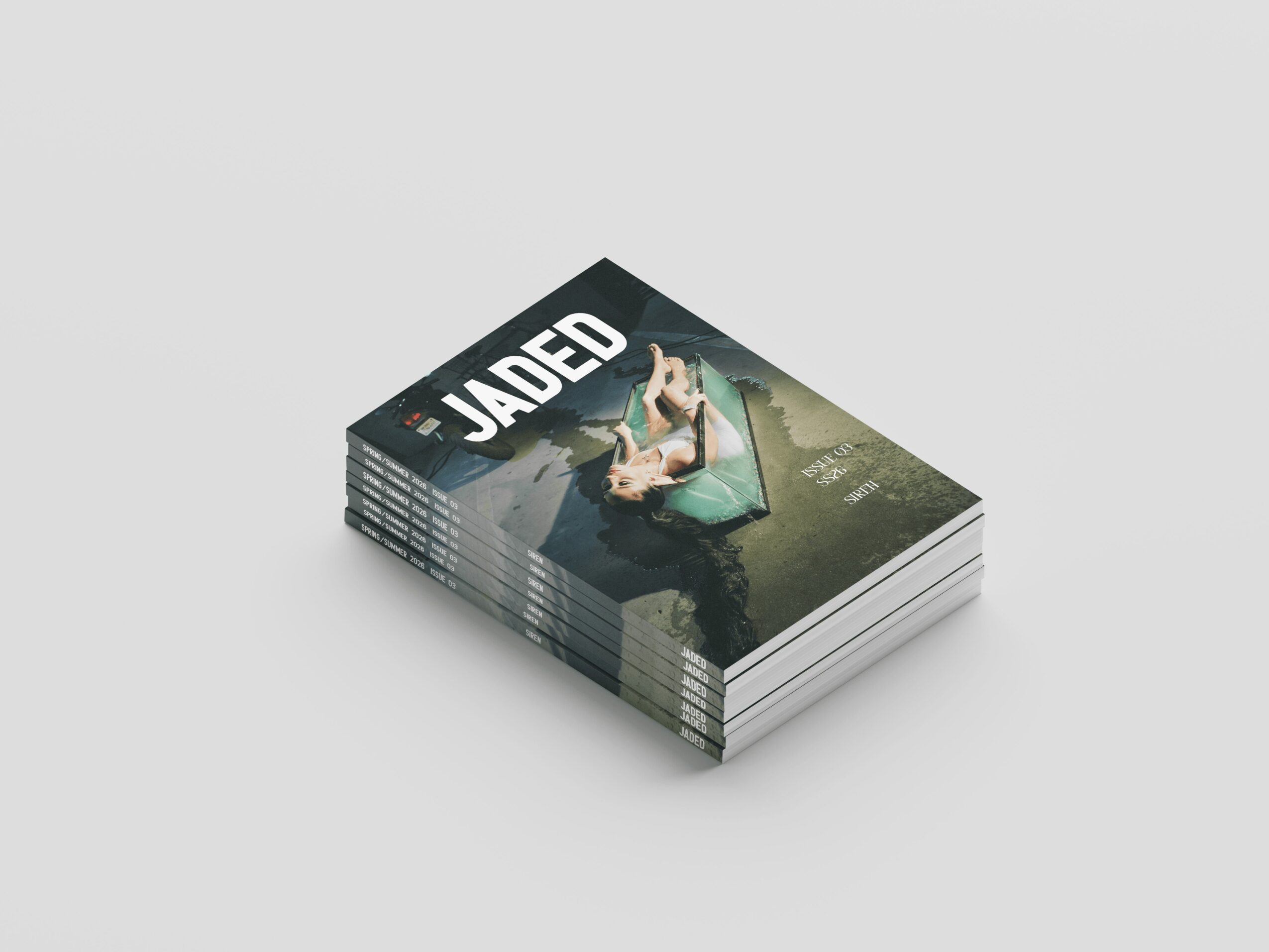 Stack of books with a cover showing a person lying on a dock, titled 'JADED'.