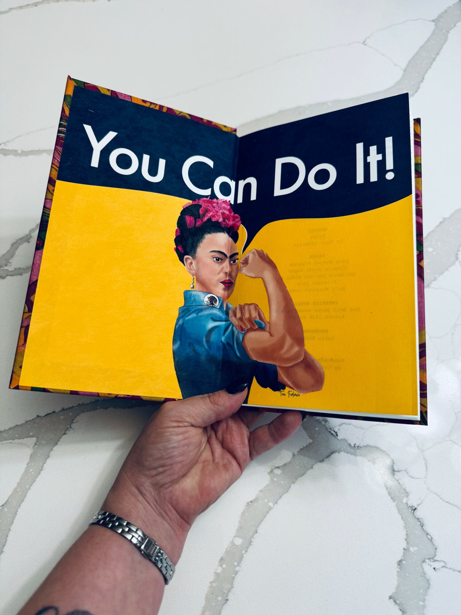 Open book with a woman in a blue shirt and pink headband flexing her arm, with text 'You Can Do It!' above.