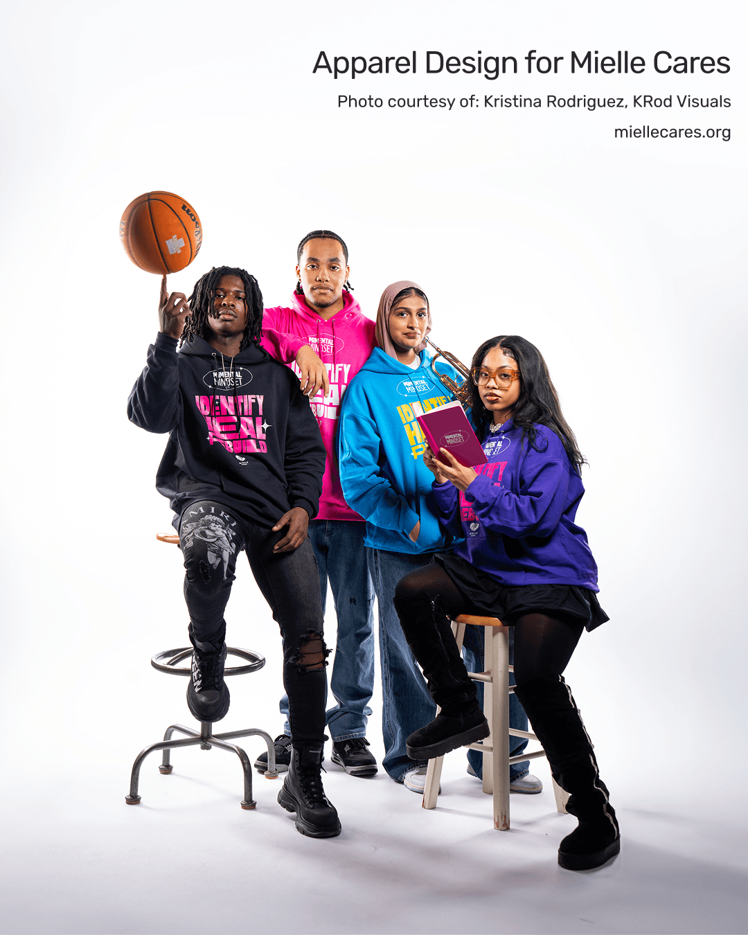 Four young people, one holding a basketball, pose with books and a stool in a studio setting.