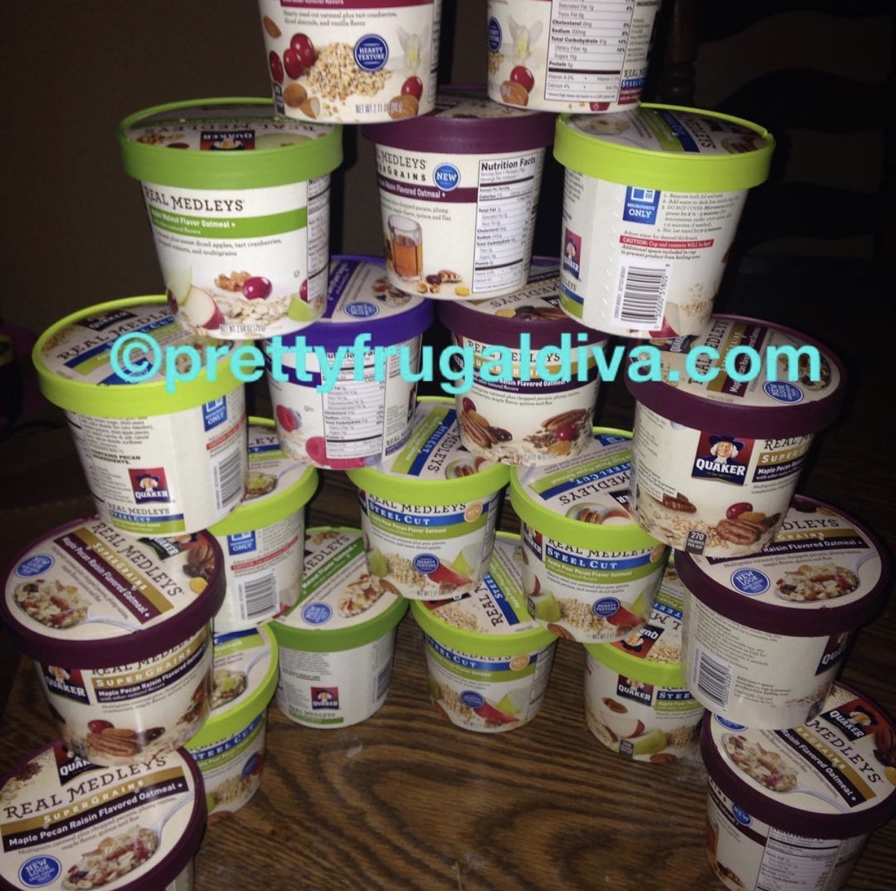 Multiple containers of ice cream stacked on a wooden surface, with a dark background.