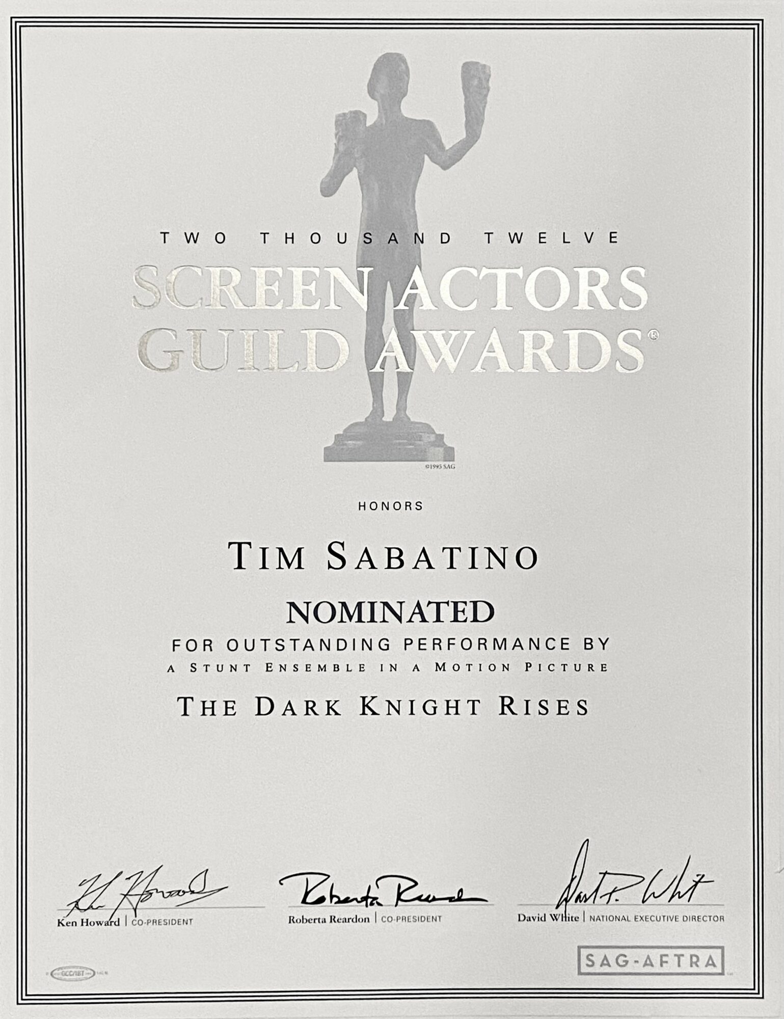 Award certificate with a silhouette of a person holding an award, text about Tim Sabatino's nomination for The Dark Knight Rises, signatures, and SAG-AFTRA logo.