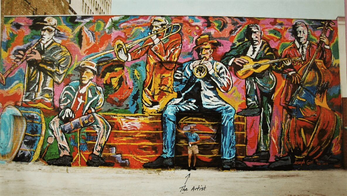 Colorful mural of musicians playing instruments, with vibrant abstract background, featuring six people, some seated and some standing.
