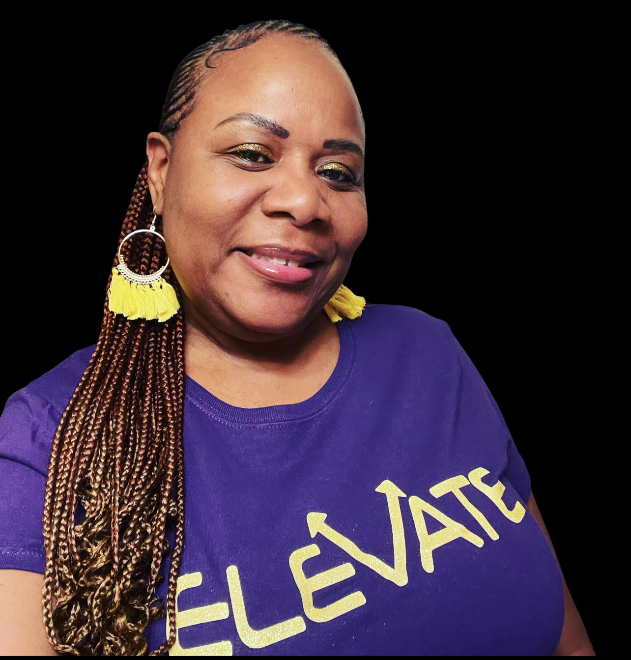 Smiling woman with braided hair, wearing a purple shirt with yellow text, against a black background.