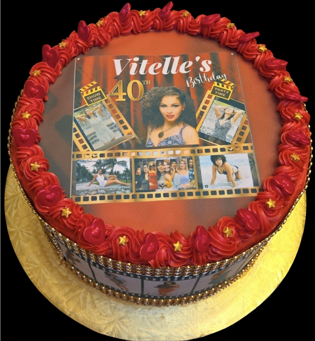 Round birthday cake with red frosting border, decorated with photos and text celebrating Vielle's 40th birthday, on a gold base.