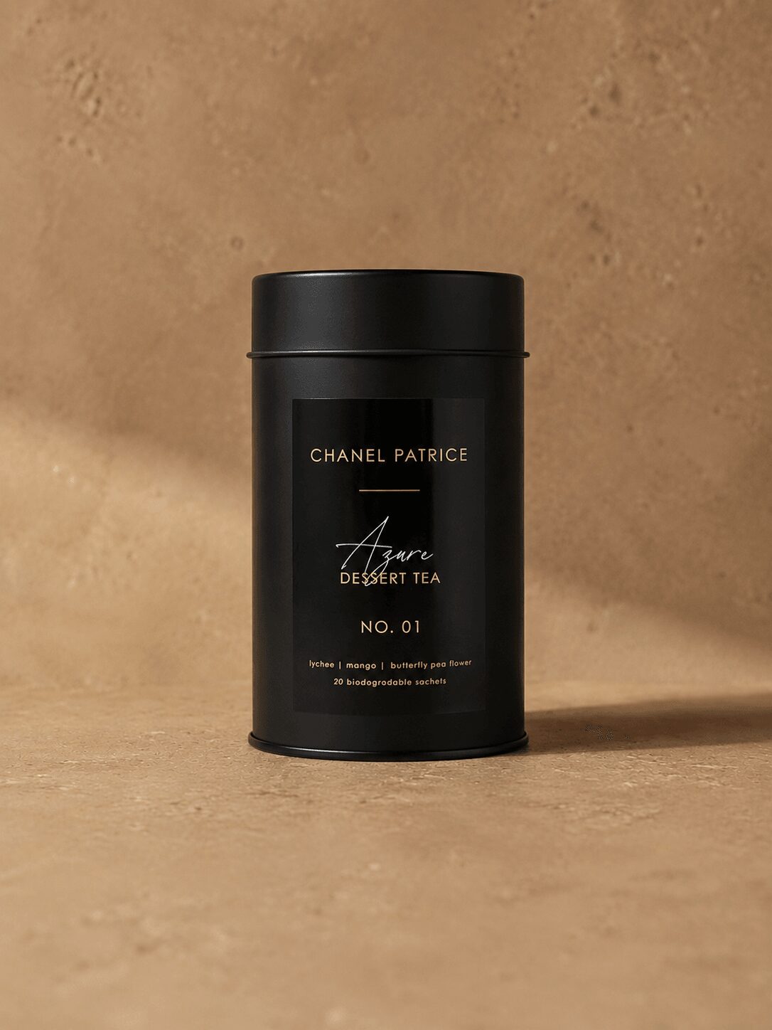 Black cylindrical container with gold and white text on a beige surface and background.