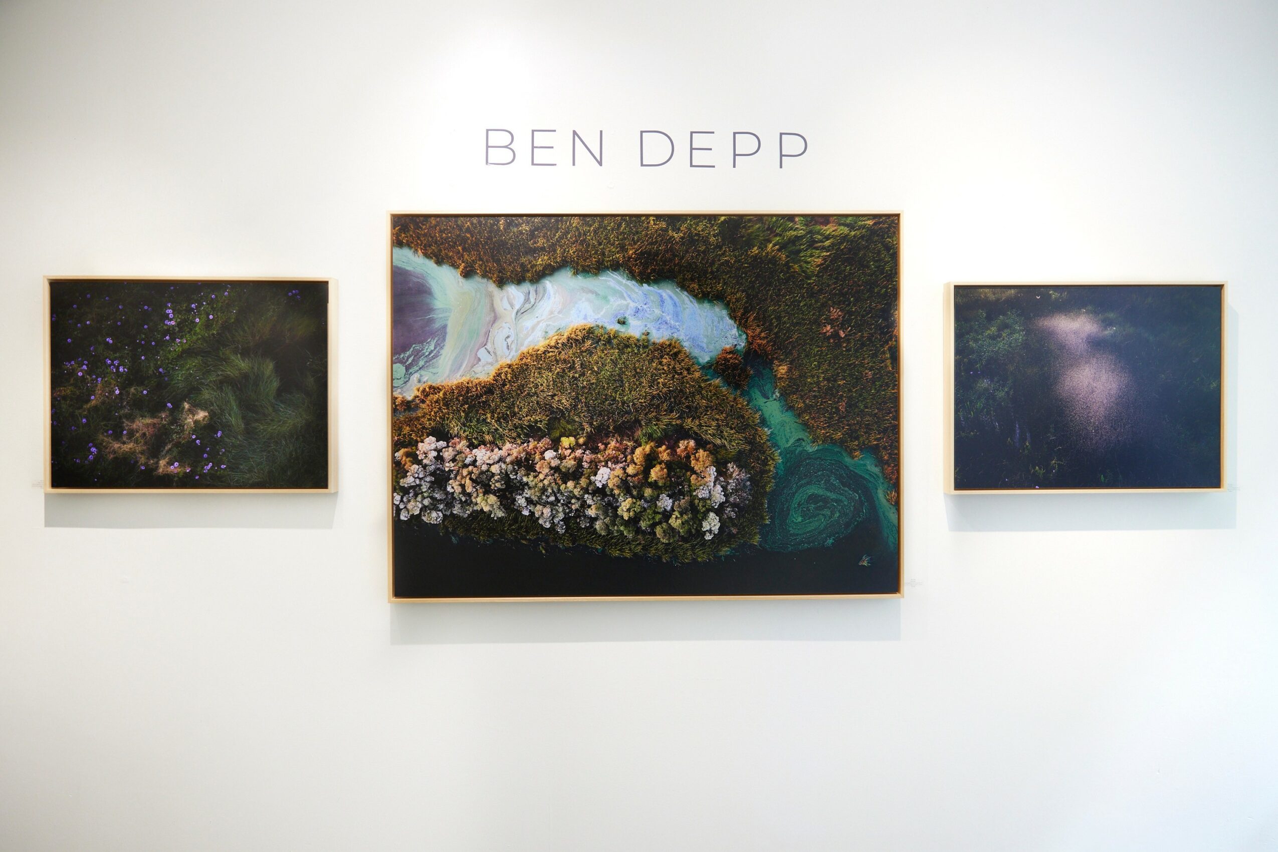 Three landscape photographs on a white wall with 'BEN DEPP' text above, centered larger photo flanked by two smaller ones.