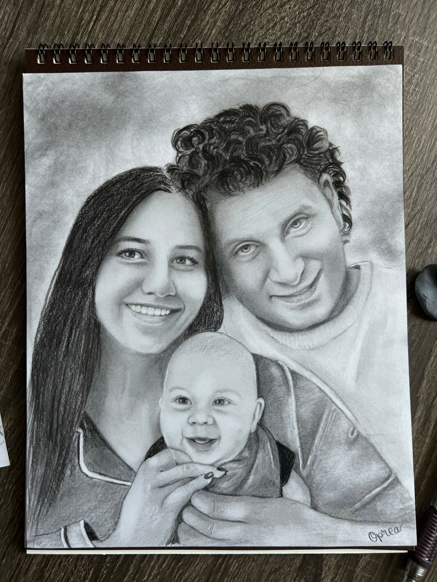 A pencil drawing of three people smiling and posing closely together, with one person making a peace sign.