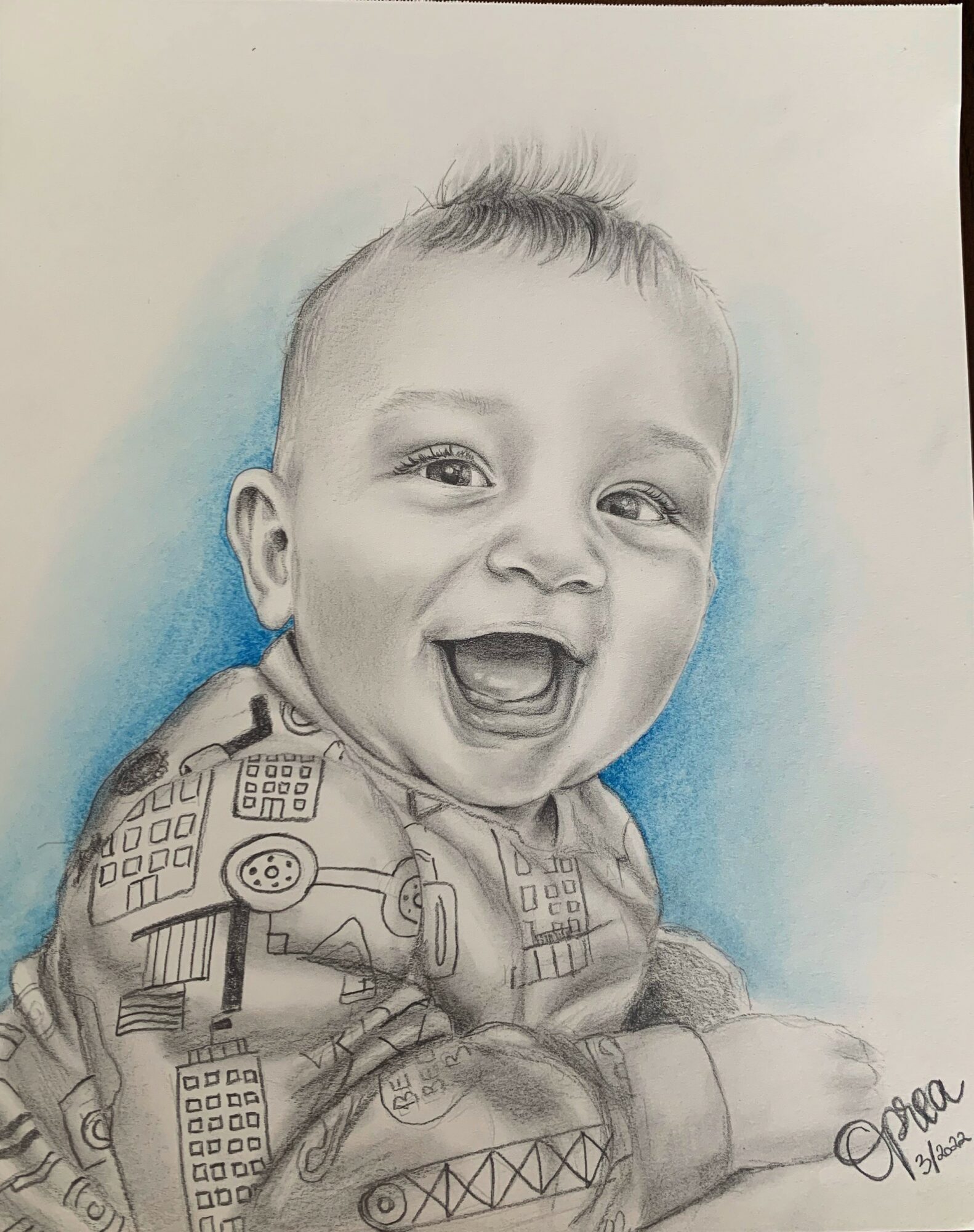 A detailed pencil drawing of a smiling baby with short hair, wearing a patterned shirt, against a light blue background.