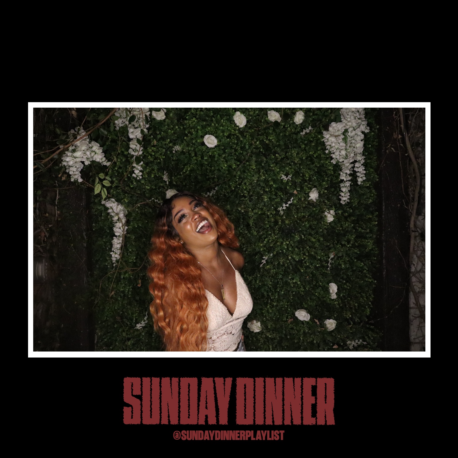 Woman with curly hair smiling in front of a green floral backdrop, with text 'SUNDAY DINNER' and social media handle below.