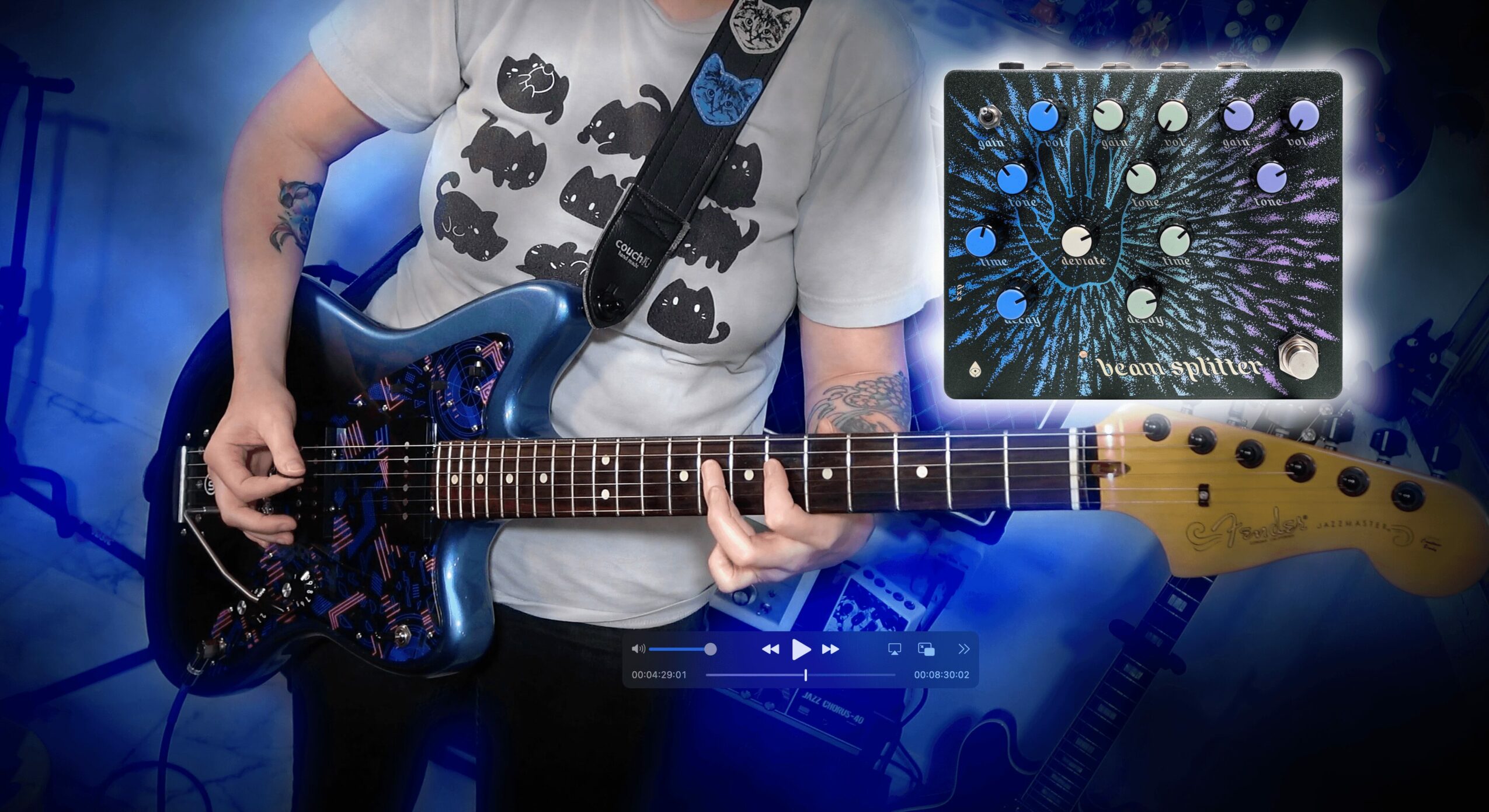 Person holding a guitar with a digital tablet displaying a colorful abstract pattern in the background.