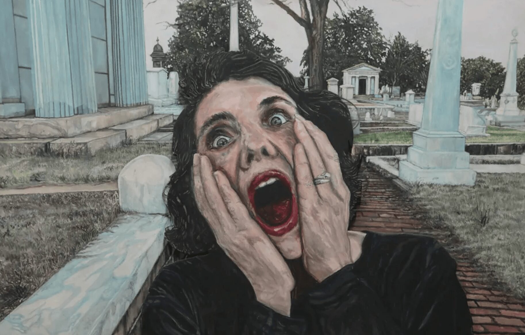 A woman with dark hair and makeup shows a shocked expression, hands on her face, outdoors near columns and trees.