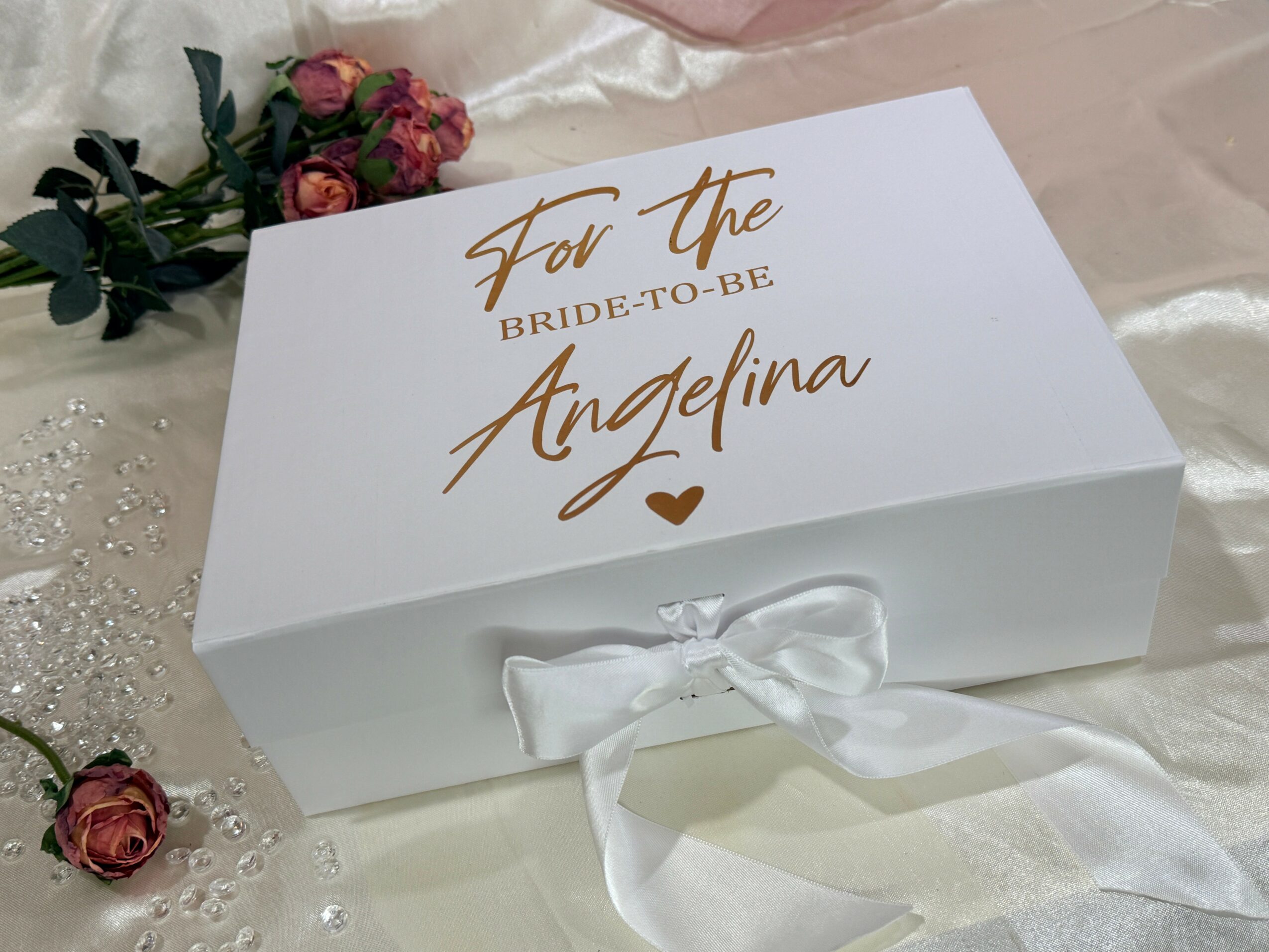 White box with a bow, decorated with pink roses and beads, and a message for the bride-to-be Angelina.