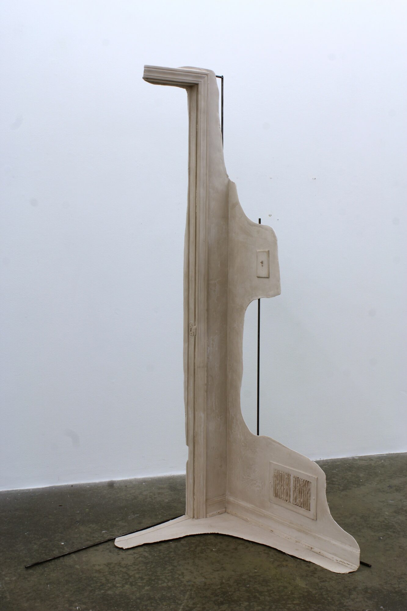 Upright medical device with a vertical arm and a base, standing against a plain background.