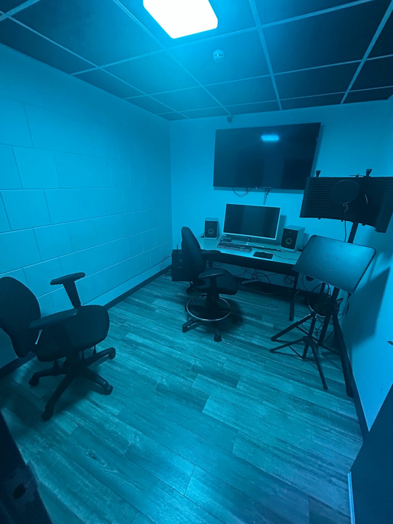 Office with chairs, desk, and electronic equipment, viewed from a rotated perspective.